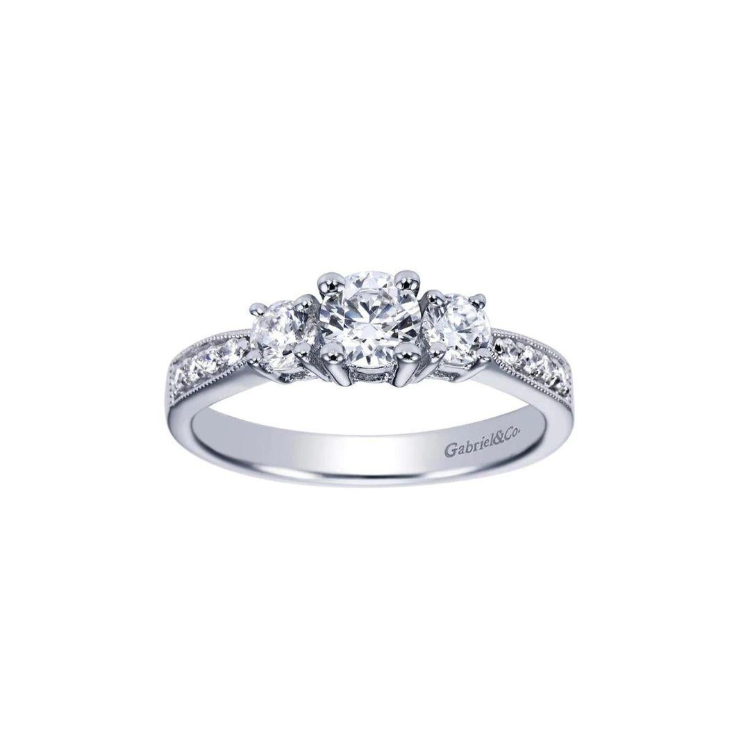 Three Stone Diamond Engagement Ring in 14k White Gold.﻿ Classic engagement ring style features timeless diamond studded channel setting. Total diamond carat weight is 0.75ctw, H color, SI1 clarity.