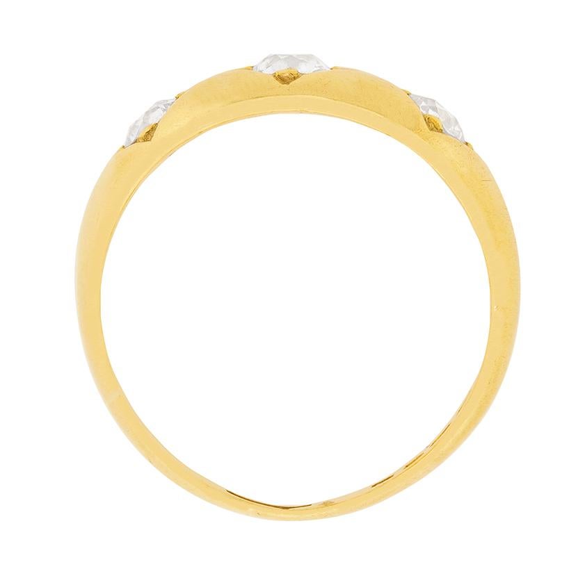 This fine example of a Victorian era three stone gypsy ring was handcrafted in 18 carat yellow gold during the latter part of the nineteenth century. The ring is centrally set with an old cut diamond flanked by two slightly smaller diamonds, all