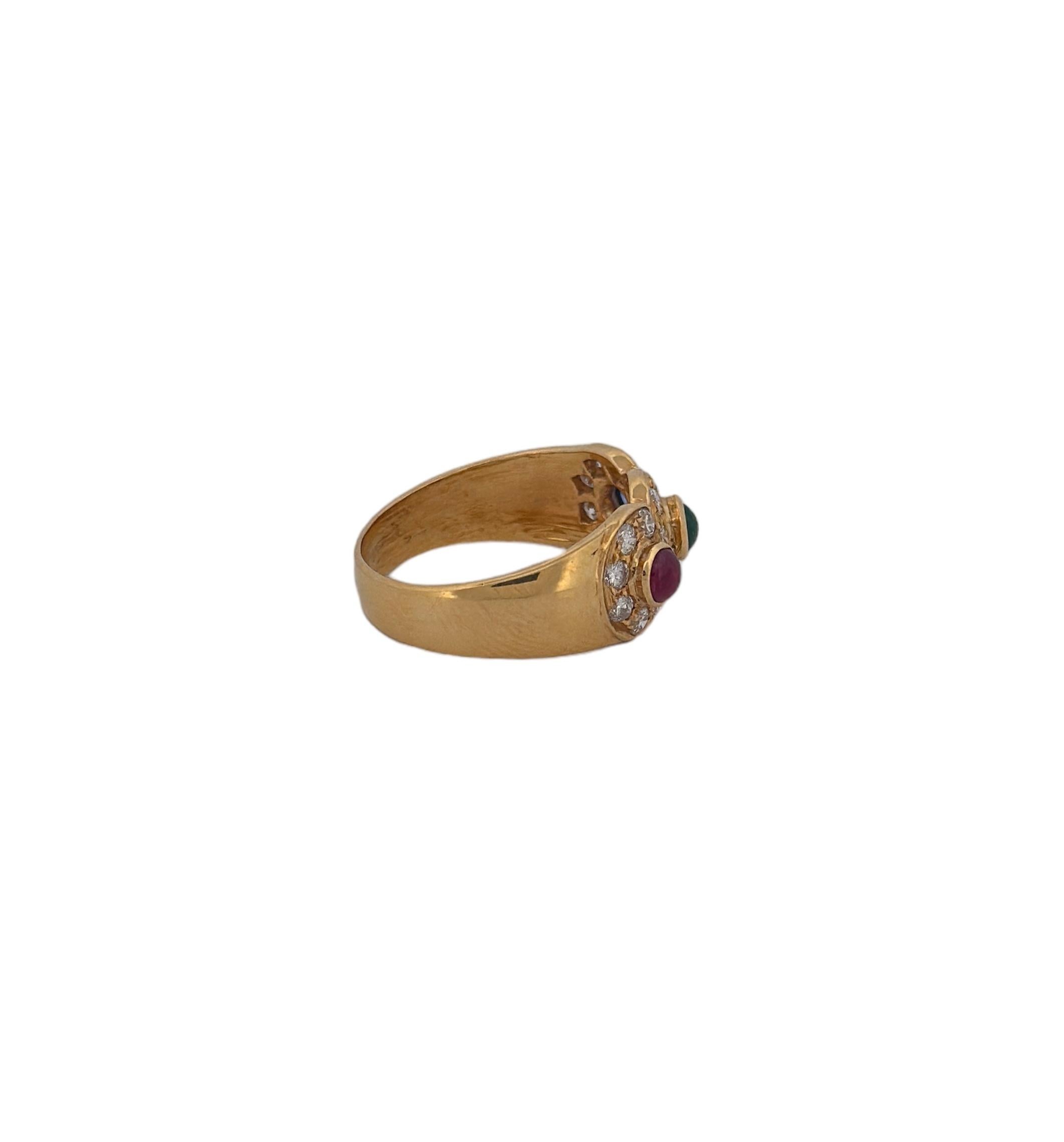 Transport yourself to the early 20th century with this truly remarkable ring, a testament to the era's unparalleled craftsmanship. Fashioned from the warm embrace of 18k yellow gold, it unveils a trinity of precious gemstones, each with its own