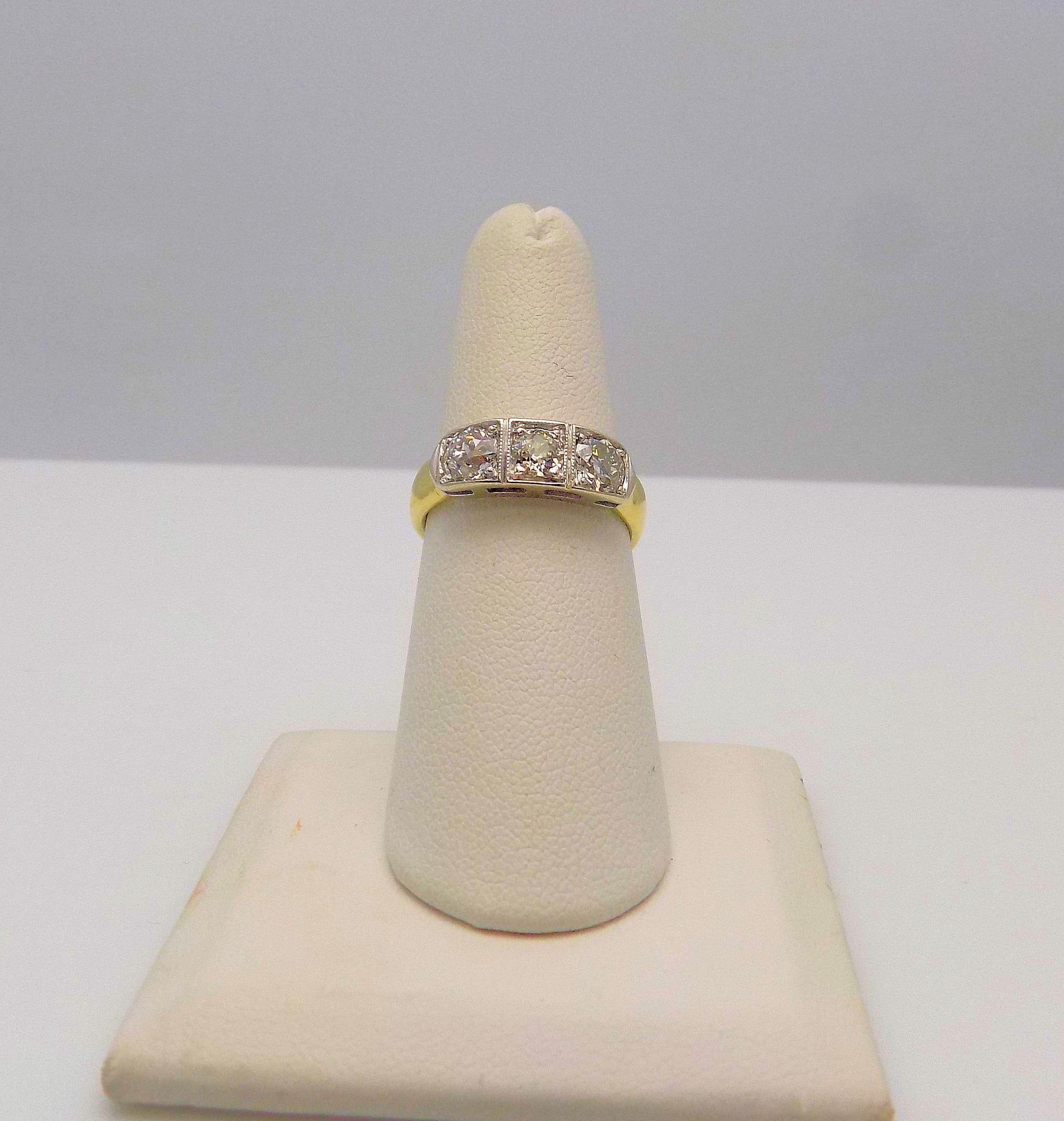 18 Karat Yellow Gold and 14 Karat White Gold 3 Stone Ring featuring 3 European Cut Diamonds 1.33 Carat Total Weight; SI1-SI2, I-J; 4 mm Band; Finger Size 7; 3.9 DWT or 6.07 Grams.