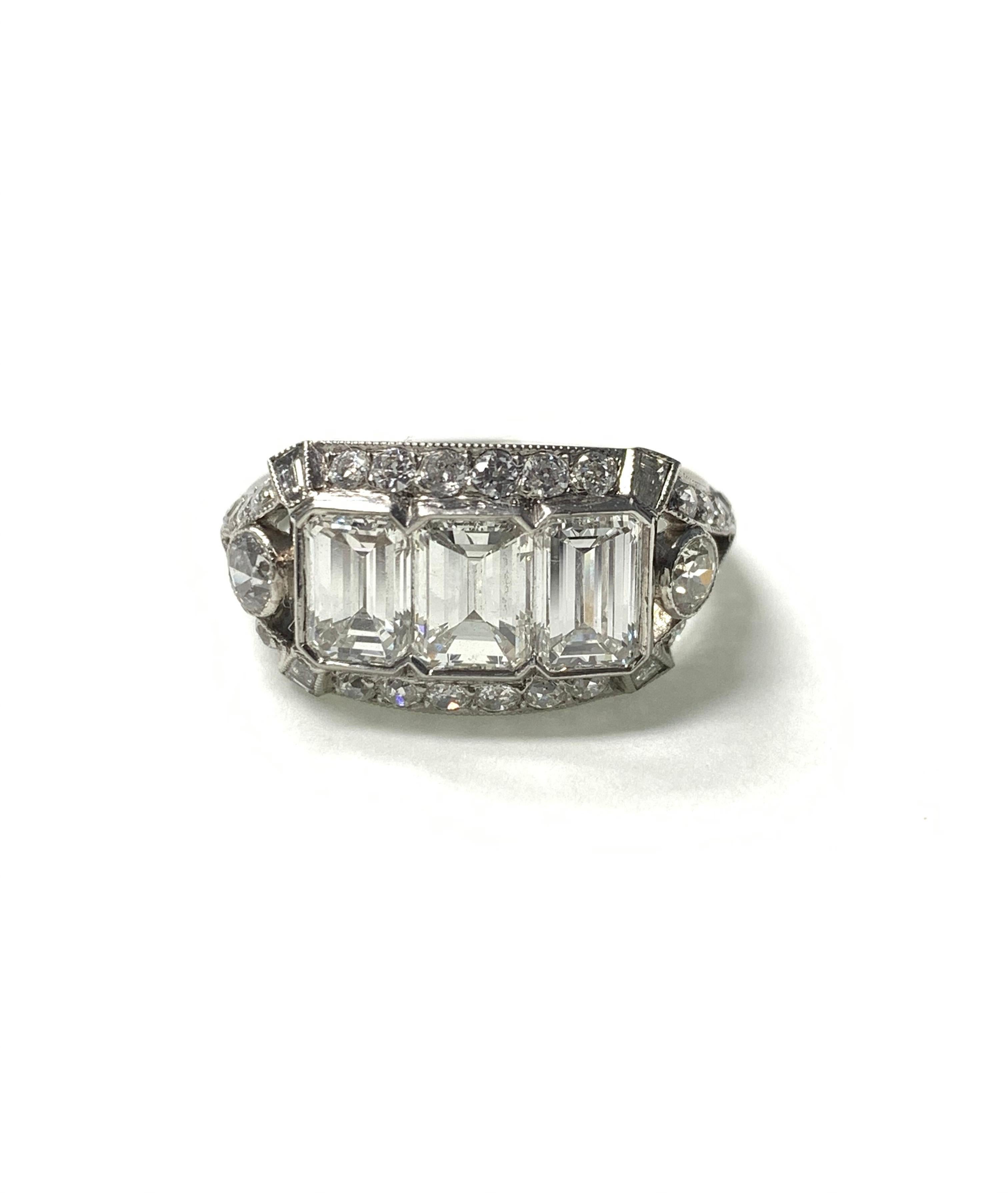 Three stone Emerald Cut Diamond ring beautifully handcrafted in platinum. 
The details are as follows : 
Diamond weight : 2.38 carat ( 3 emerald cut diamonds) H color and VS clarity 
Diamond weight : 1.10 carat ( small diamonds ) ( GH color and VS