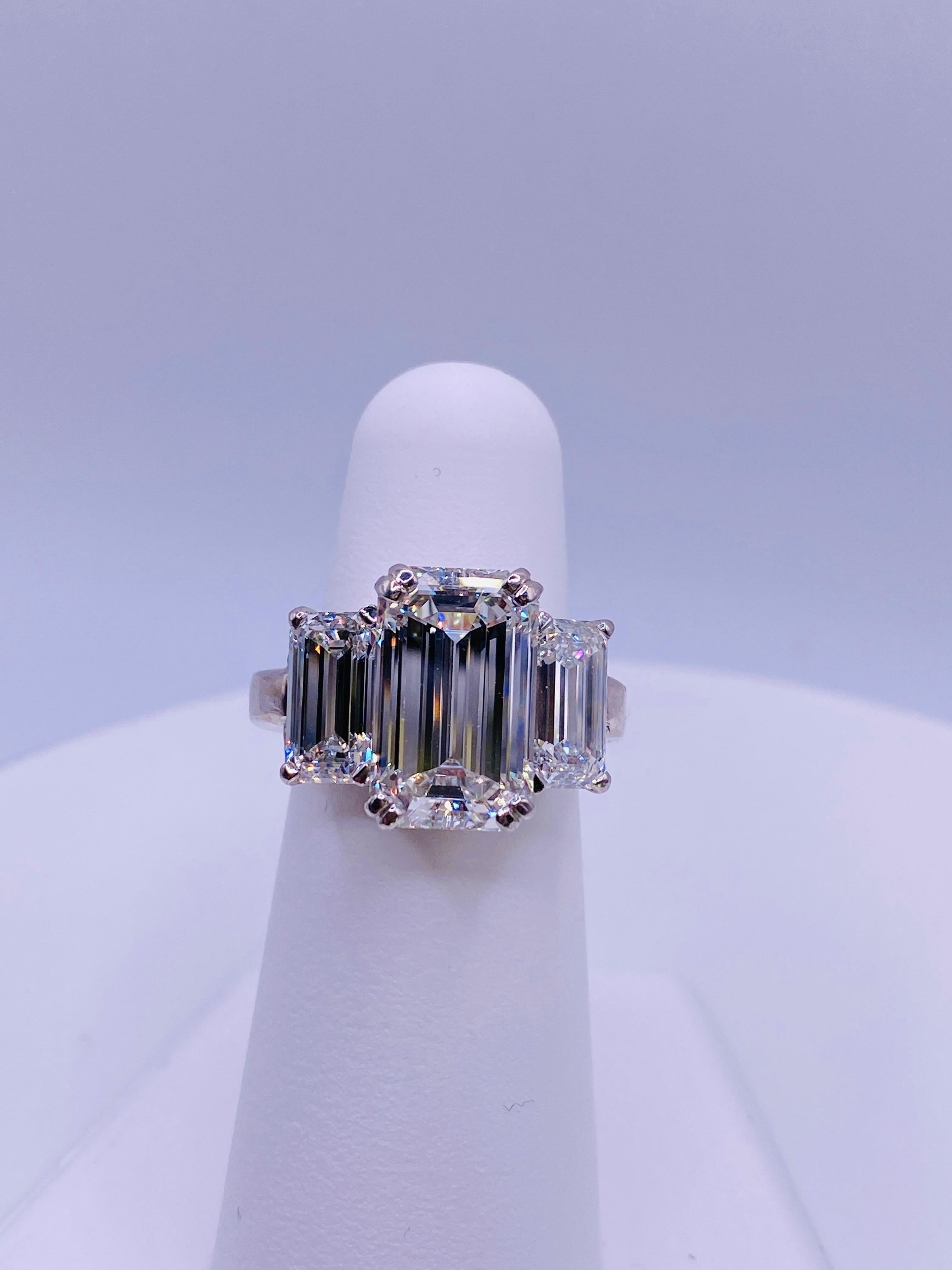 14K white gold and platinum ring with 6.1 carat F Vs1 GIA certified emerald-cut center diamond with 2= 2.9 carat total weight E Vs1 emerald-cut side diamonds. Setting is platinum, shank is 14K white gold. Size 5.5
