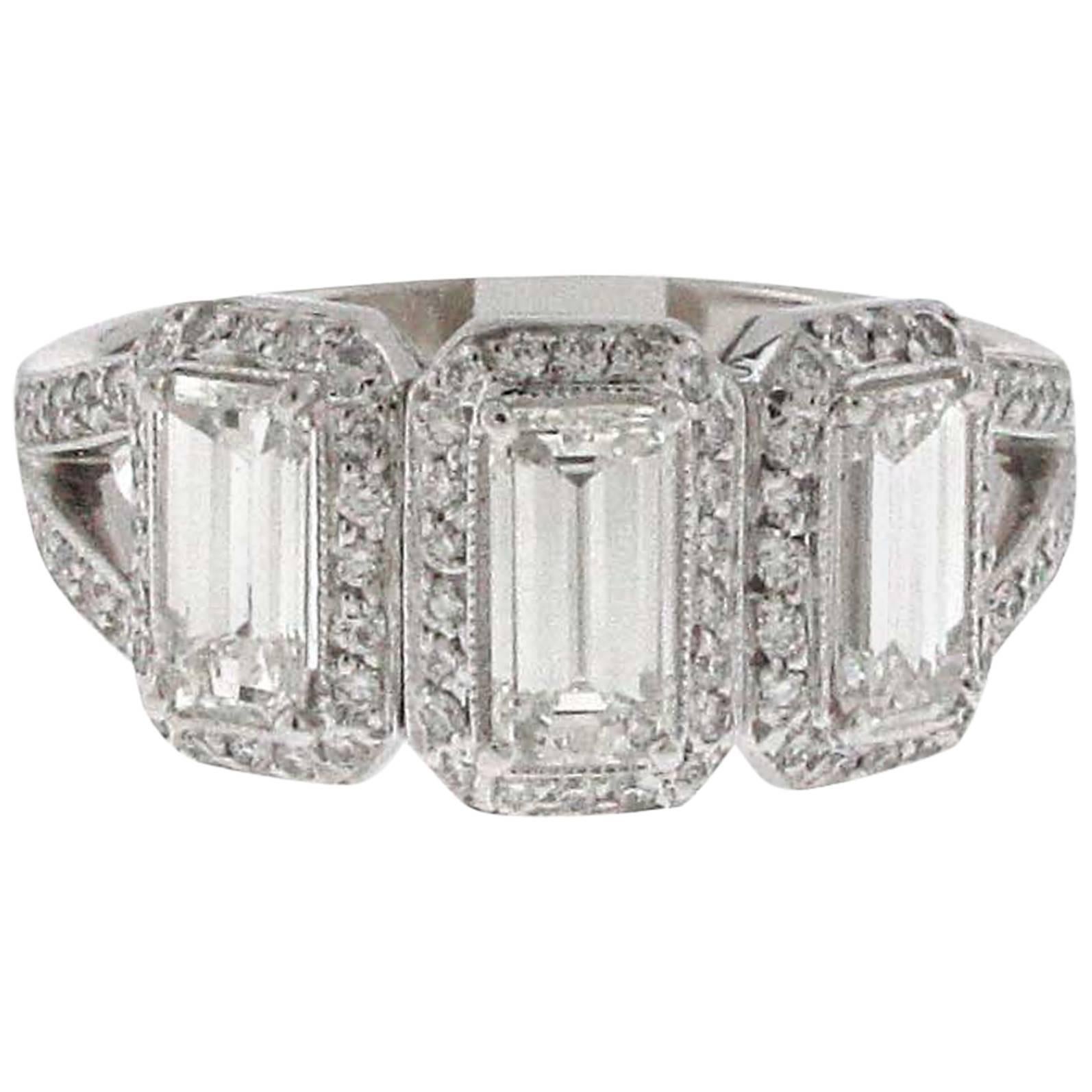 Three-Stone Emerald Cut White Diamond Halo Ring Set in Platinum