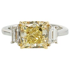 Three-Stone Fancy Yellow 3.49 Carat Cushion Cut Platinum Diamond Engagement Ring