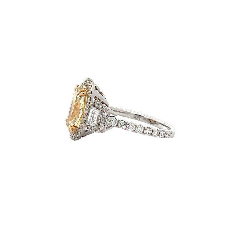Get ready to be blown away by the breathtaking beauty of this three-stone ring! Featuring a stunning oval-shaped fancy yellow diamond, this ring boasts a center stone weighing an impressive 2.48 carats. Accompanying the yellow diamond are two