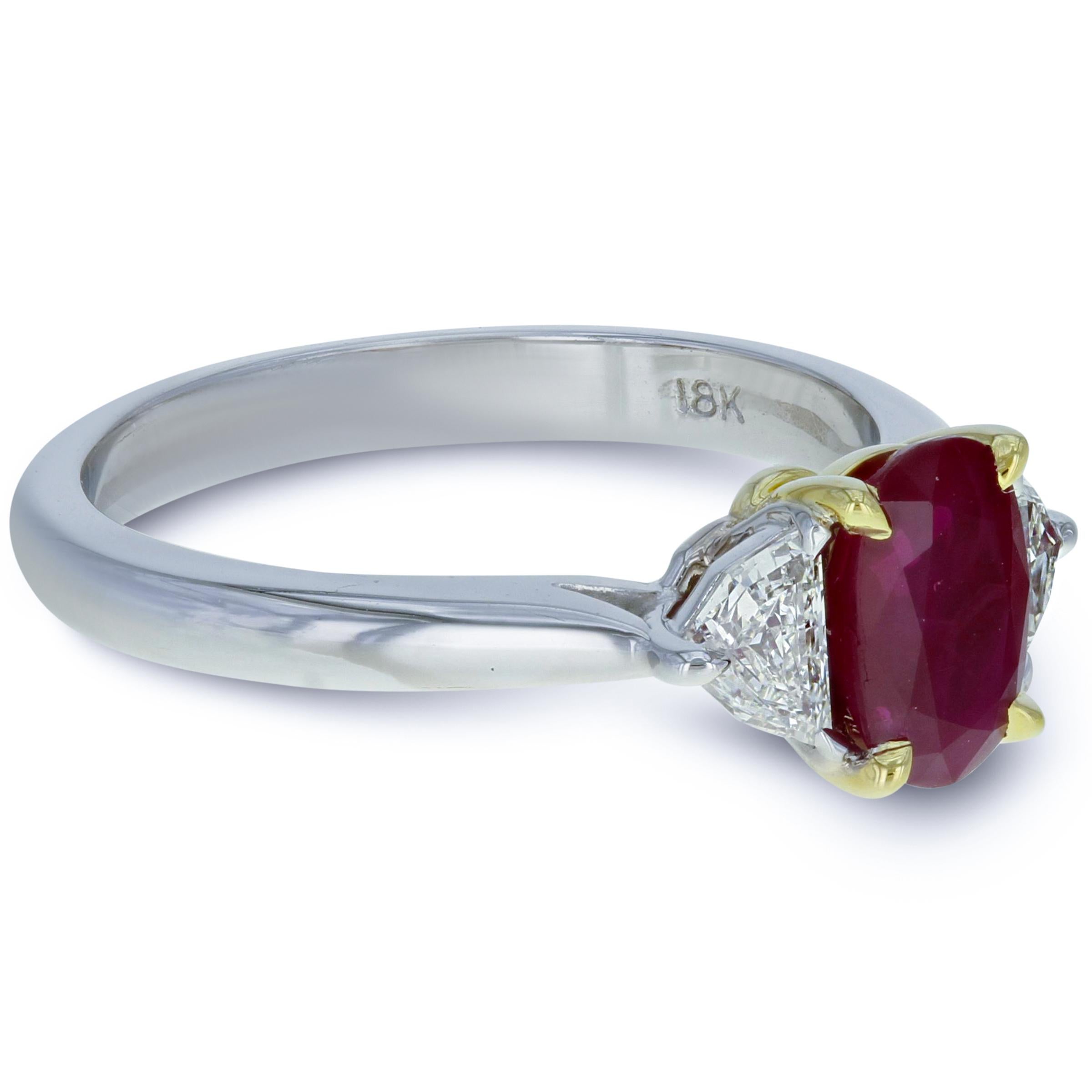 Handmade three stone ruby diamond engagement ring. Crafted in 18K white gold and starring a sweet and luscious natural Burmese ruby, weighing 1.36 carats. The crystalline gemstone boasts incredible color and hue and is GIA certified. It is flanked
