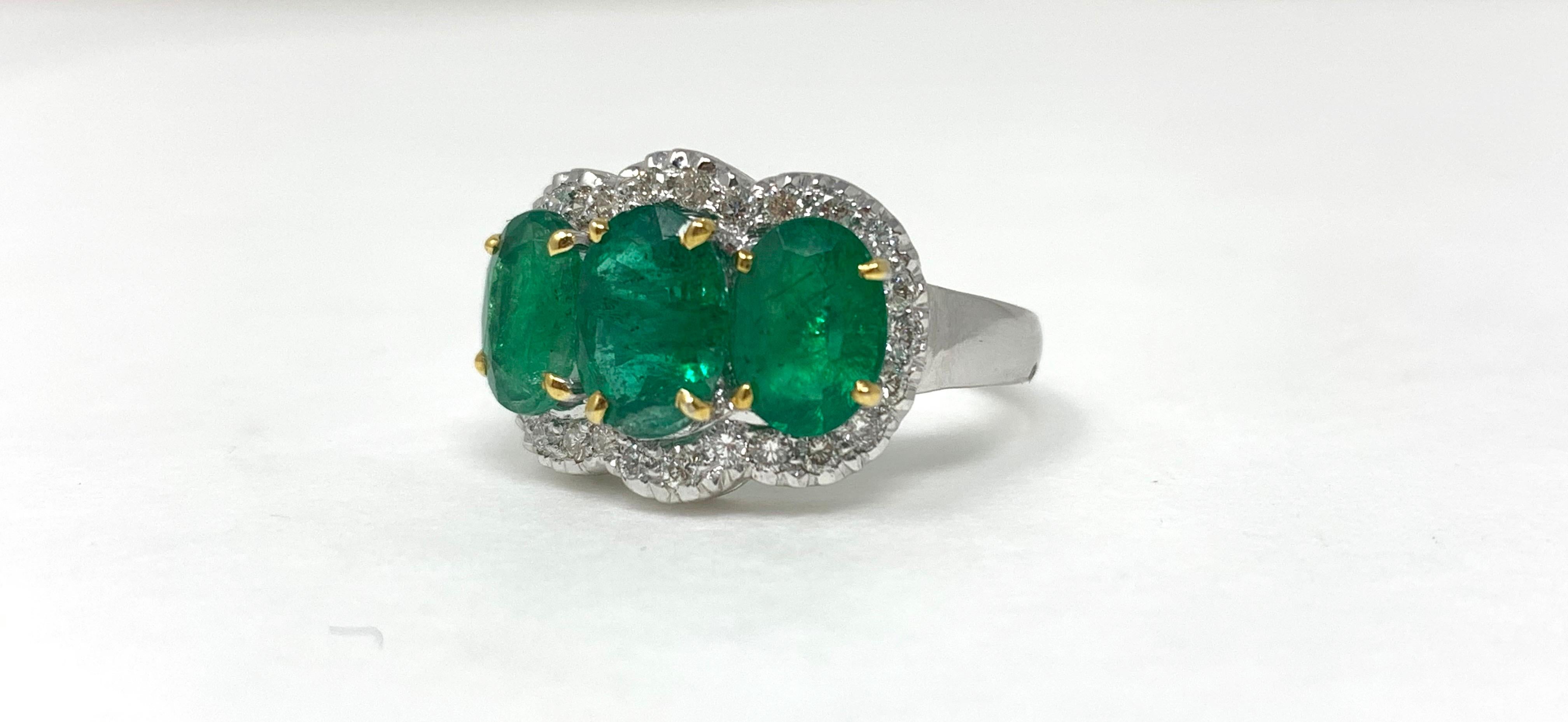 Oval Cut Three-Stone Oval Emerald and Diamond Ring in 18 Karat White Gold