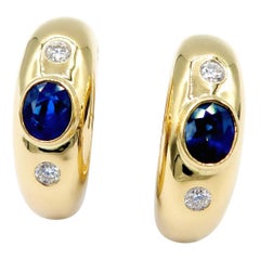 Three-Stone Oval Royal Blue Sapphire & Diamond Huggie Hoops in 18K Yellow Gold