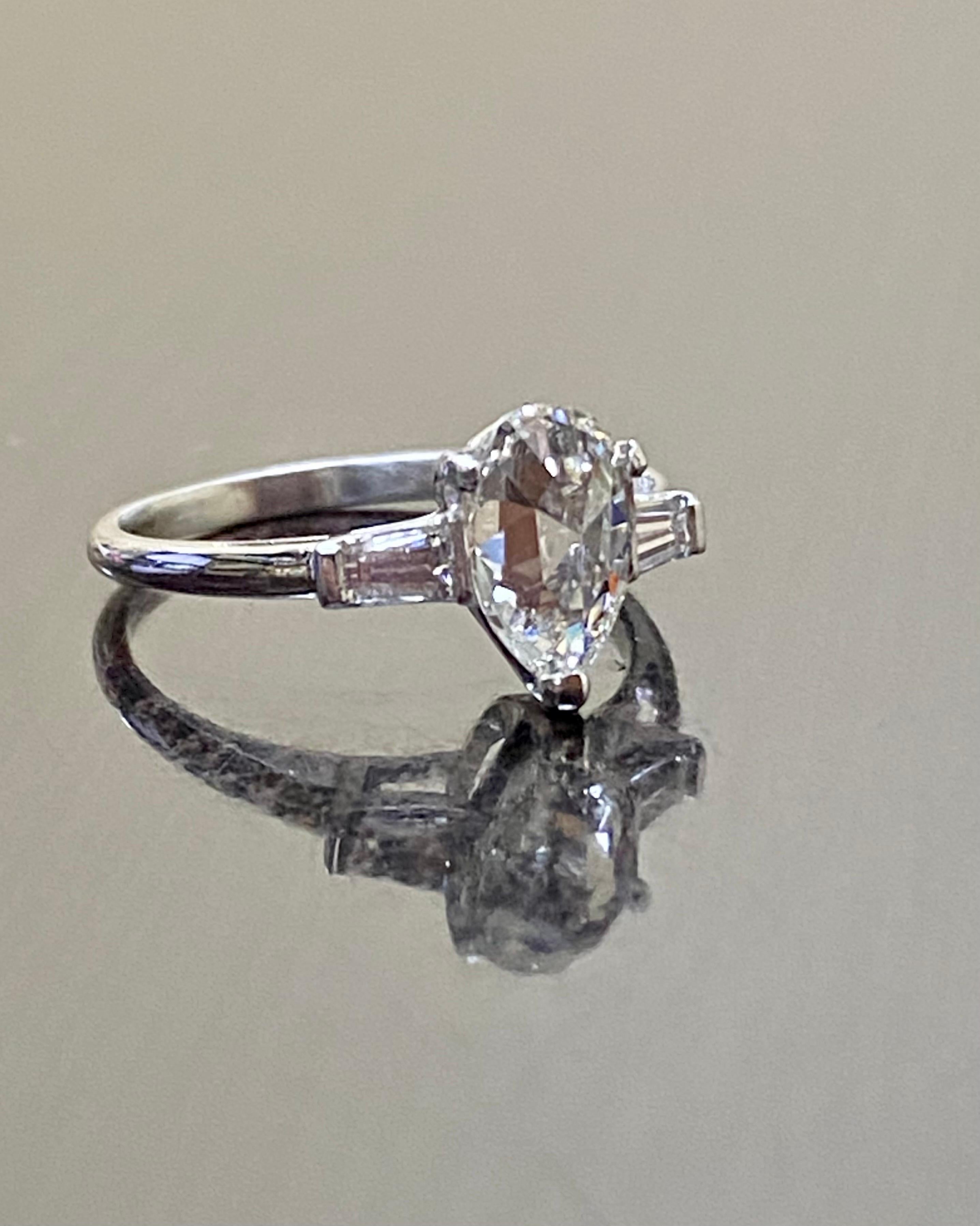 DeKara Designs Collection

Metal- 90% Platinum 10% Iridium.

Stones- EGL USA Certified Pear Shape Diamond H-I Color VS2-SI1 Clarity 1.12 Carats, 2 Baguette Diamonds G-H Color VS1-2 Clarity 0.25 Carats.

Ring Comes With EGL Certificate and
