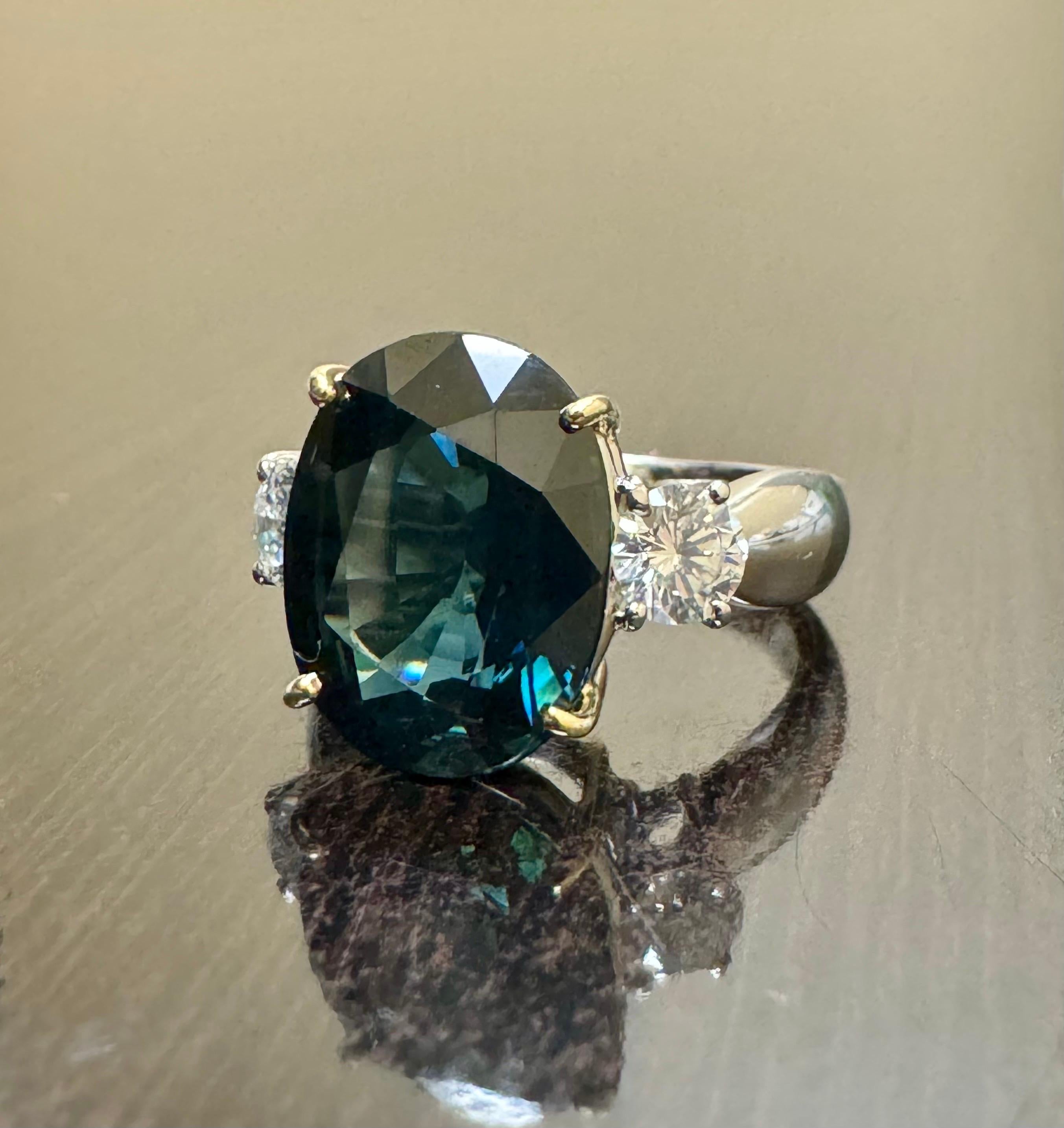 DeKara Design Collection

Metal- 90% Platinum, 10% Iridium.

Stones- Genuine Oval Greenish Blue Peacock Sapphire 7.85 Carats.  2 Round Diamonds H-I Color SI1 Clarity 0.63 Carats.

Size- 5 3/4.  FREE SIZING!!!!

Handmade Platinum Three Stone