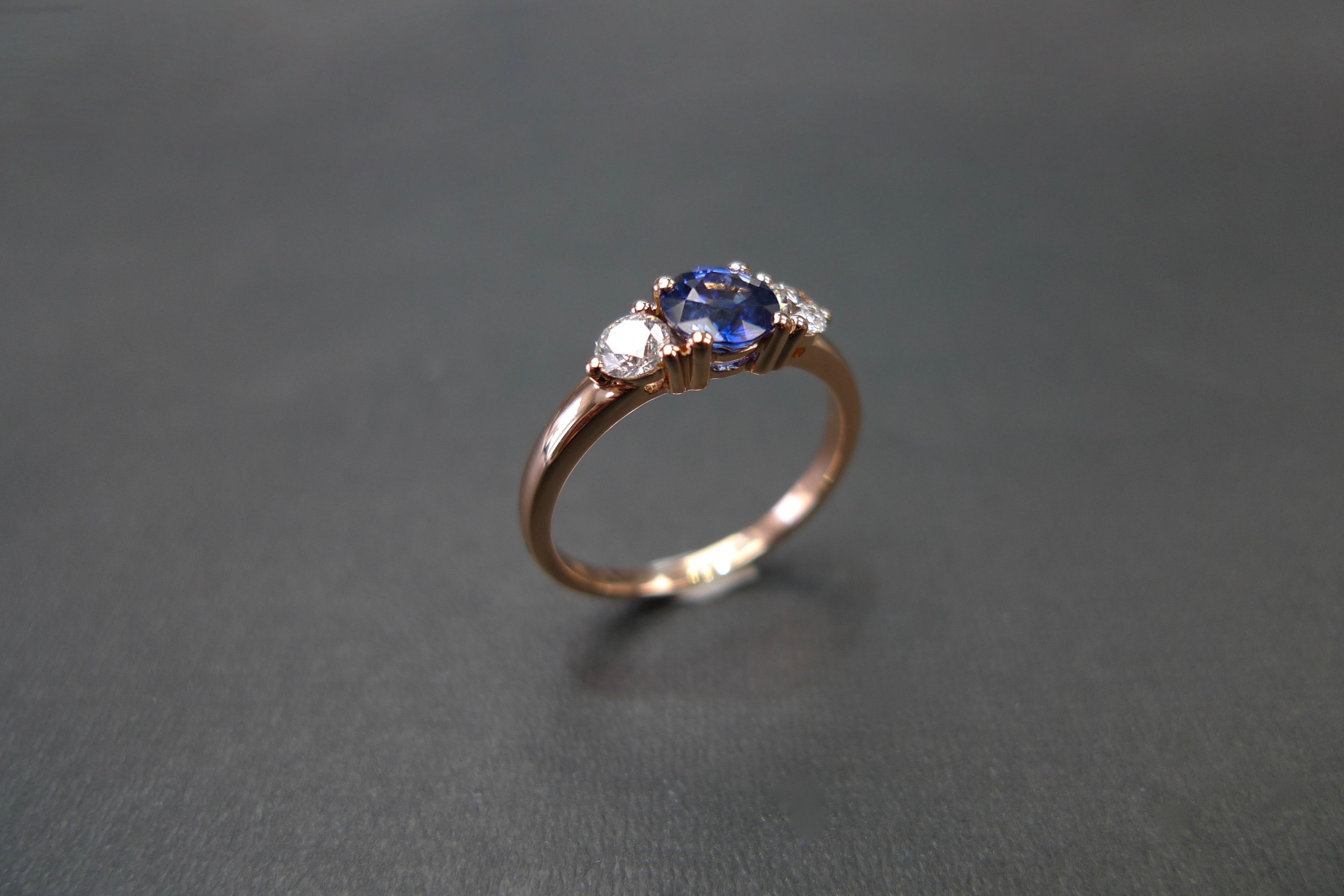 For Sale:  Three-Stone Ring with Blue Sapphire and Round Brilliant Cut Diamond in Rose Gold 10