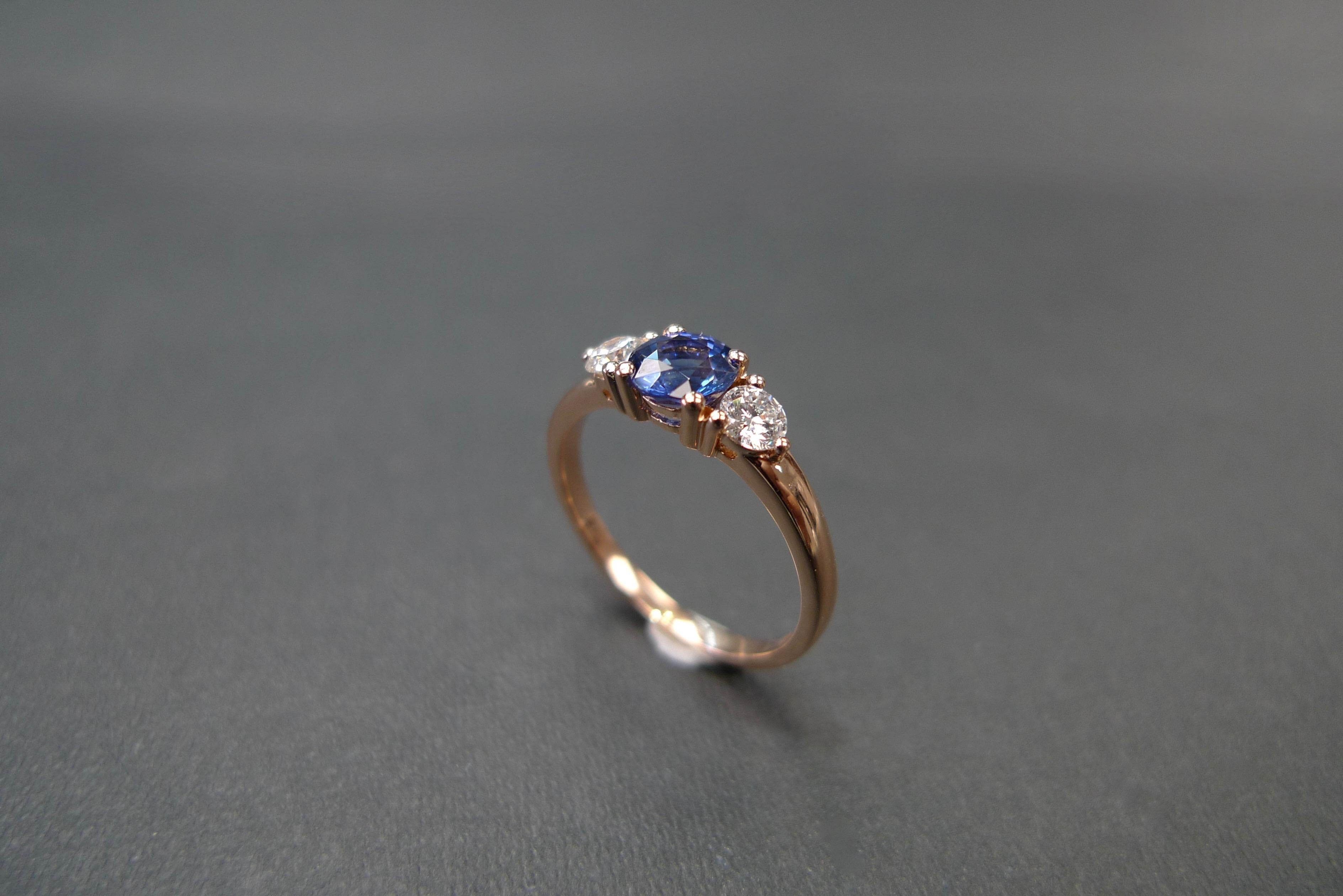 For Sale:  Three-Stone Ring with Blue Sapphire and Round Brilliant Cut Diamond in Rose Gold 12