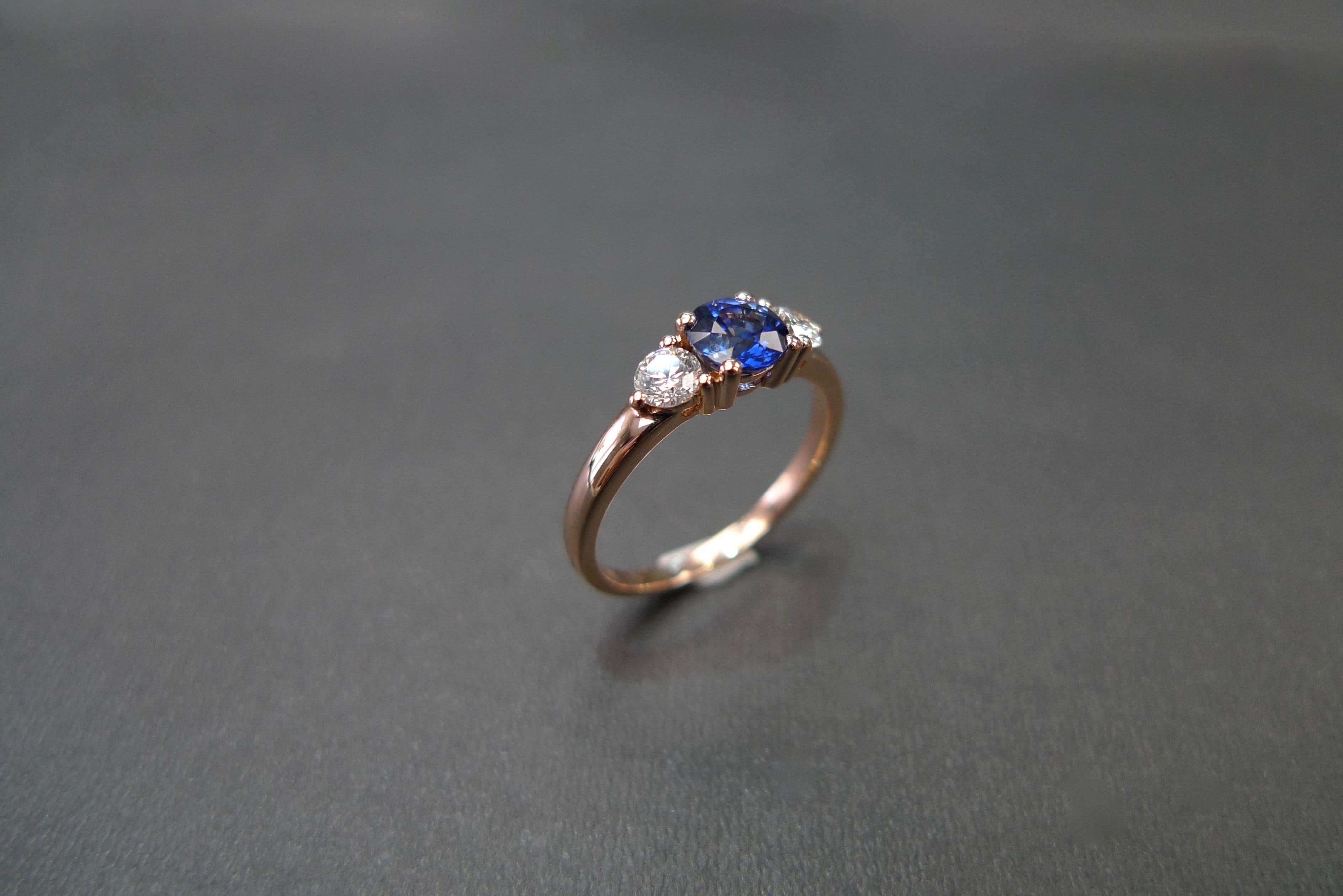 For Sale:  Three-Stone Ring with Blue Sapphire and Round Brilliant Cut Diamond in Rose Gold 9