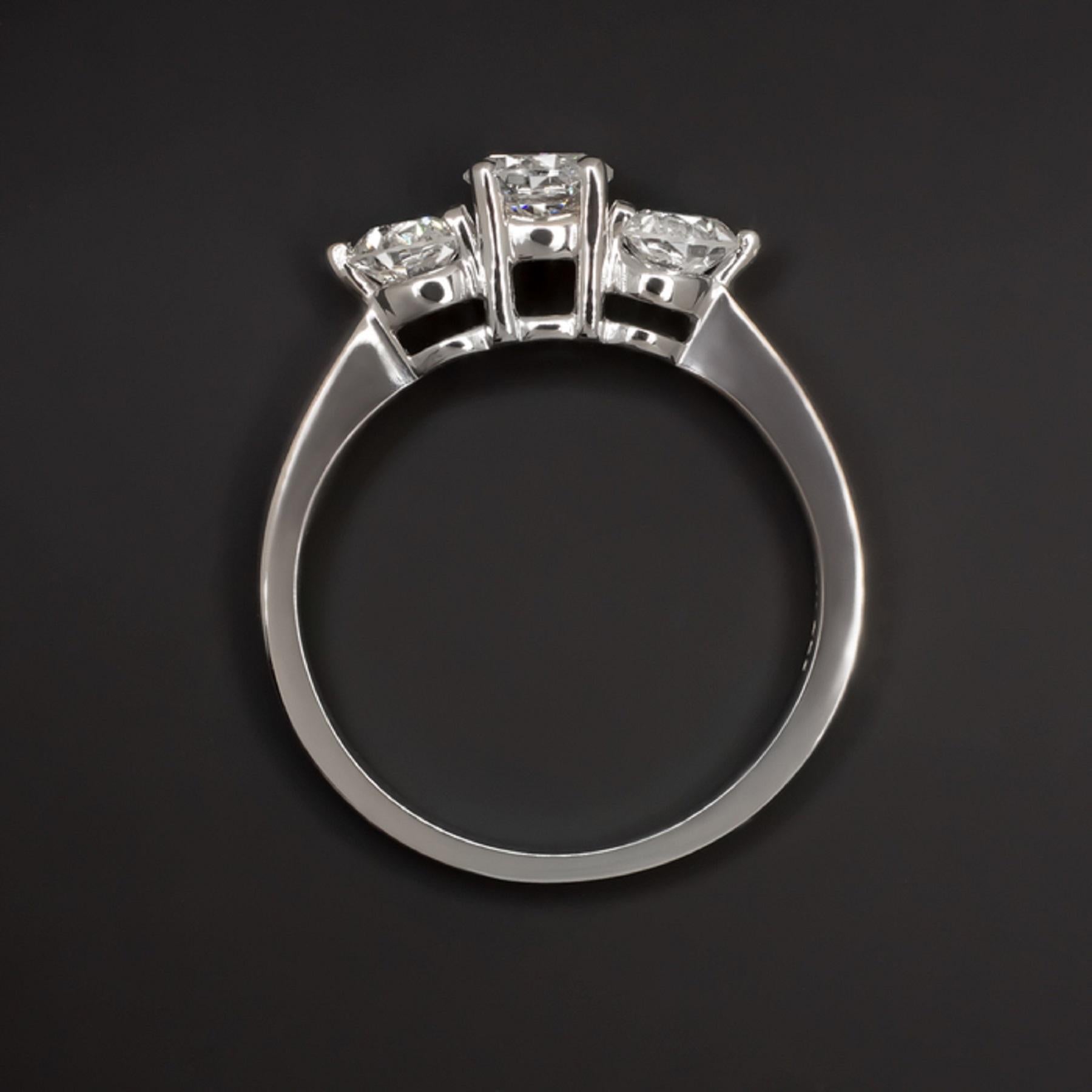 This gorgeous diamond engagement ring combines striking sparkle with an eternally stylish design. 

The 0.47 carat center diamond is completely eye clean, colorless, and ideal cut with a stunning play of light. It is flanked by two more excellent