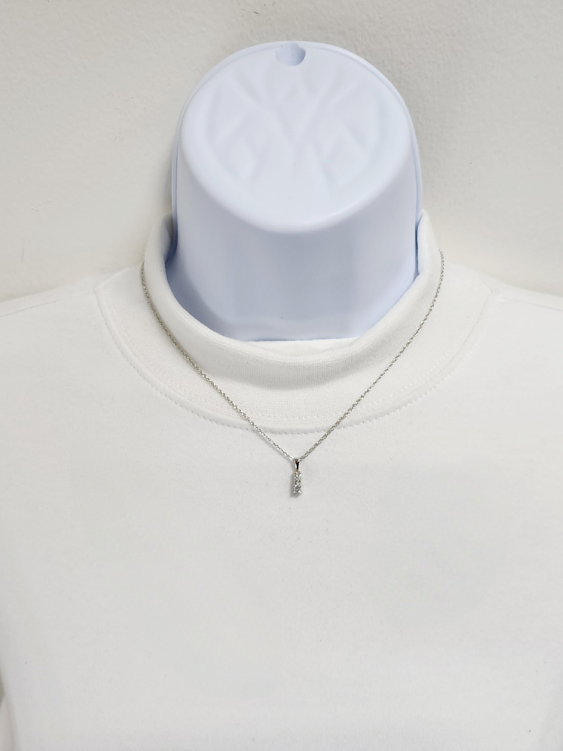 Beautiful 0.10 ct. good quality white diamond rounds in a handmade 14k white gold mounting.  Length of chain is 16