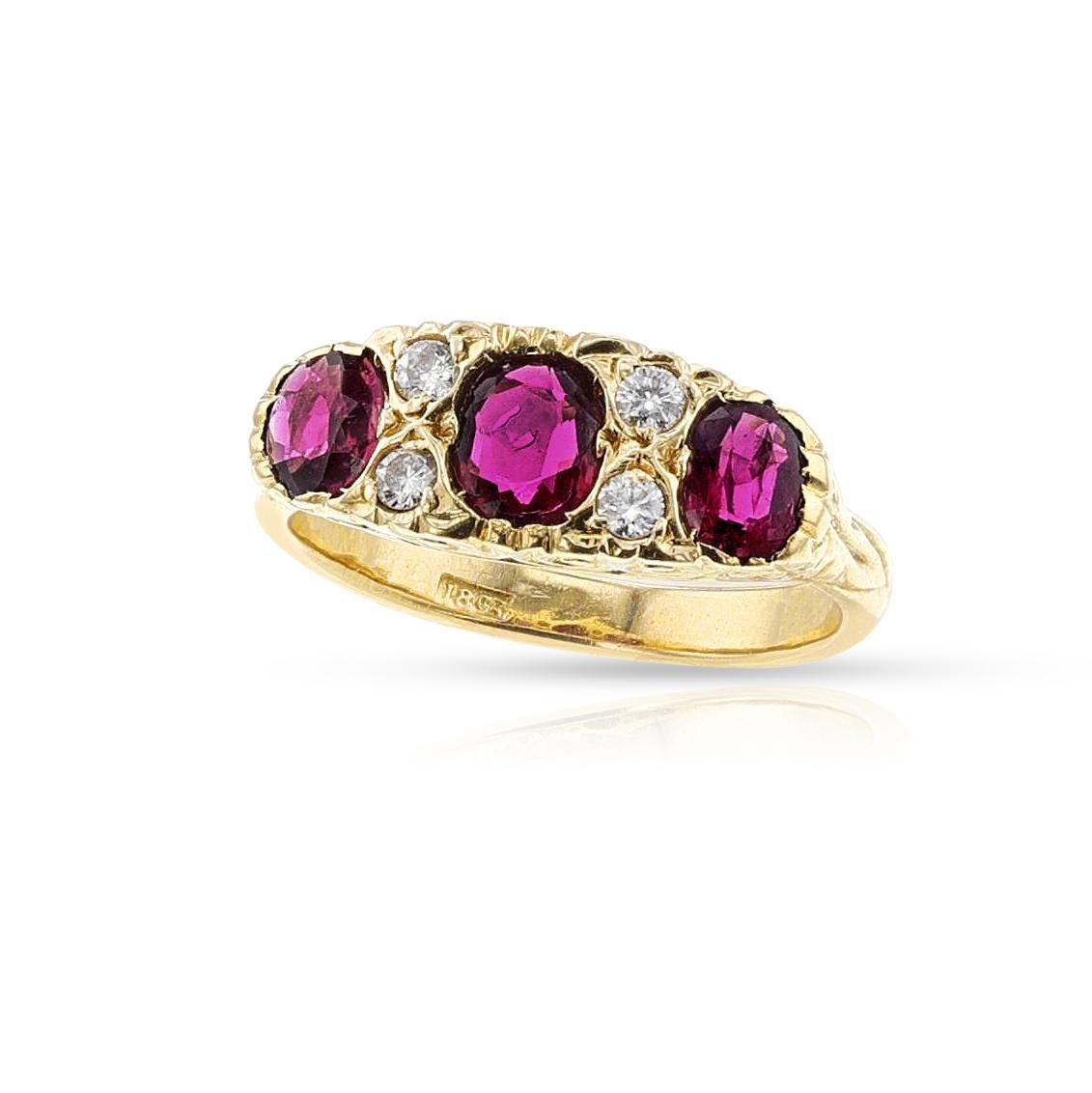 Anello con tre pietre di rubino e diamanti in oro giallo 18 carati. I rubini sono a forma di cuscino e i diamanti sono a taglio brillante. Il peso totale dell'anello è di 5,5 grammi. Misura dell'anello US 6.75.


