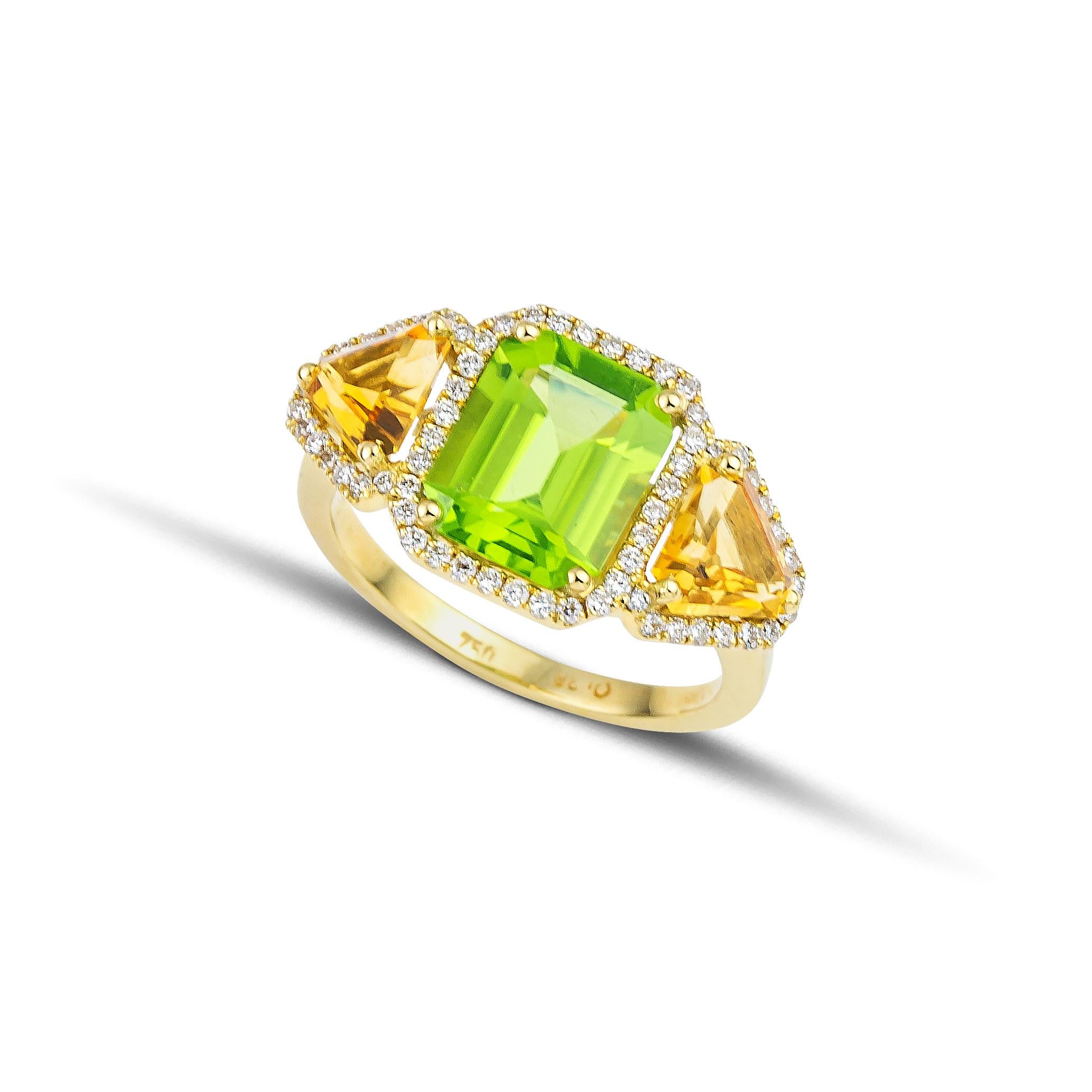 Three stones ring made of 18Kt yellow gold with center emerald cut green peridot and two trillion citrines elegantly framed by brilliant cut diamonds. The peridot is carefully set among four gold prongs and the citrines are set among three gold