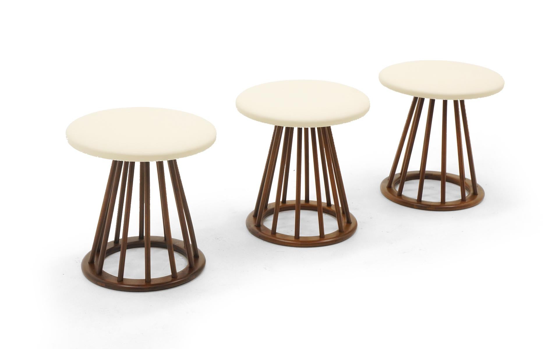 Set of 3 stools designed by Arthur Umanoff, 1950s. Expertly refinished and reupholstered with new off white / ivory leather tops. Together they also make a nice substitute for a bench. Beautiful set.