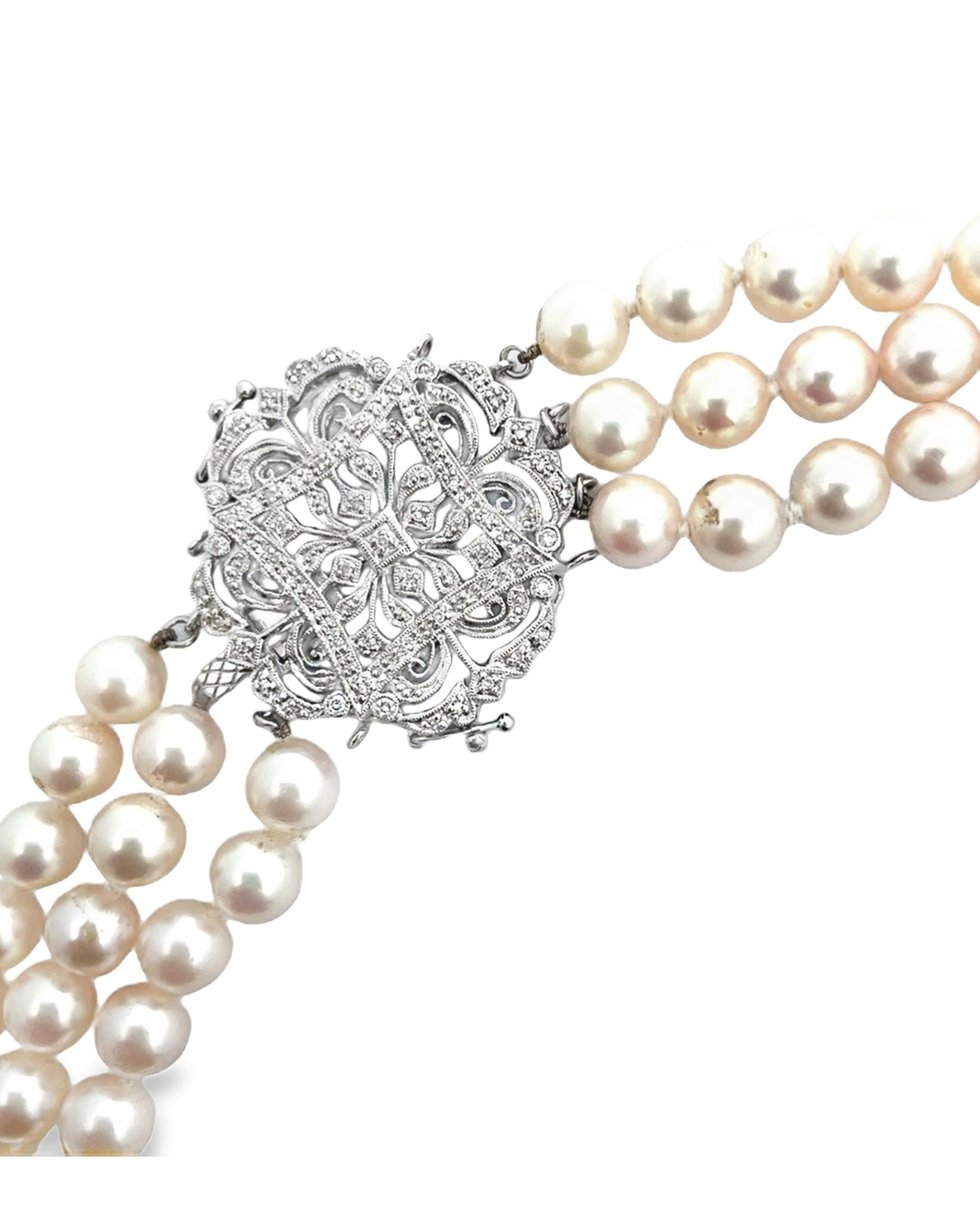 Three strand cultured pearl necklace adorned with 14K white gold antique inspired clasp.  The clasp is furnished with round faceted diamonds. Pearls measure from 7.5mm - 7.85mm.  

- Necklace is 16 inches. 