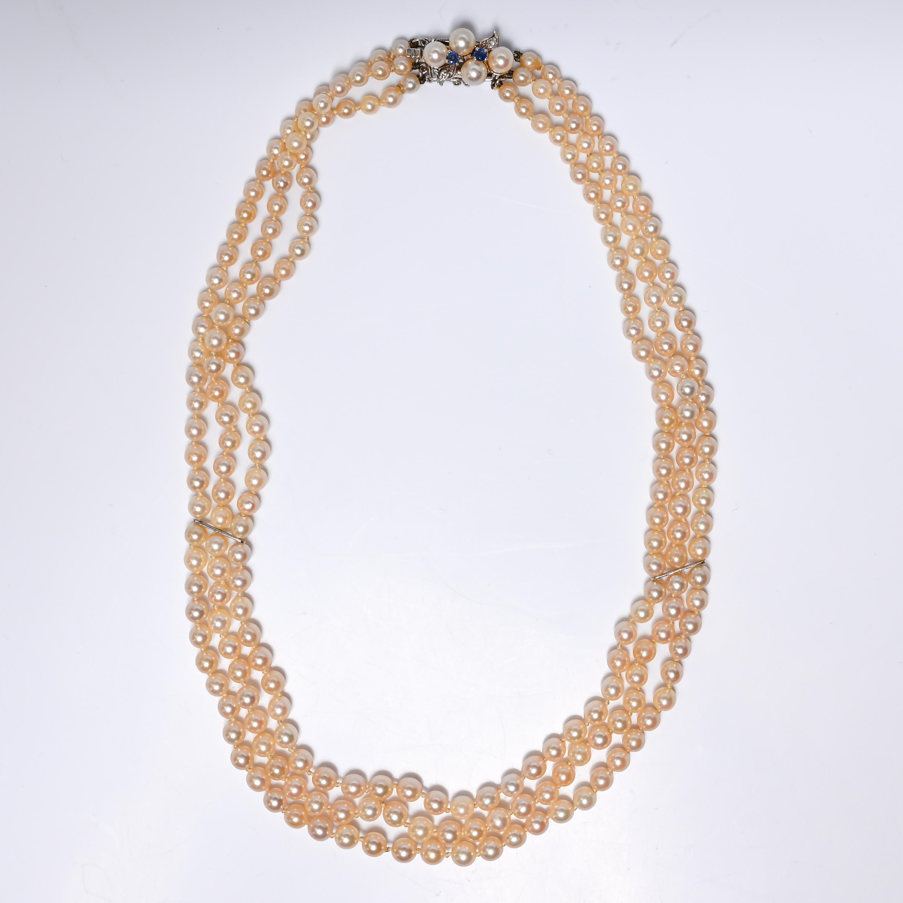 This exquisite three-strand cultured Akoya pearl necklace dates to the late Art Deco to early Retro era, circa 1930s–1940s—a period widely considered the pinnacle of pearl culturing craftsmanship. The necklace features luminous, gently graduated