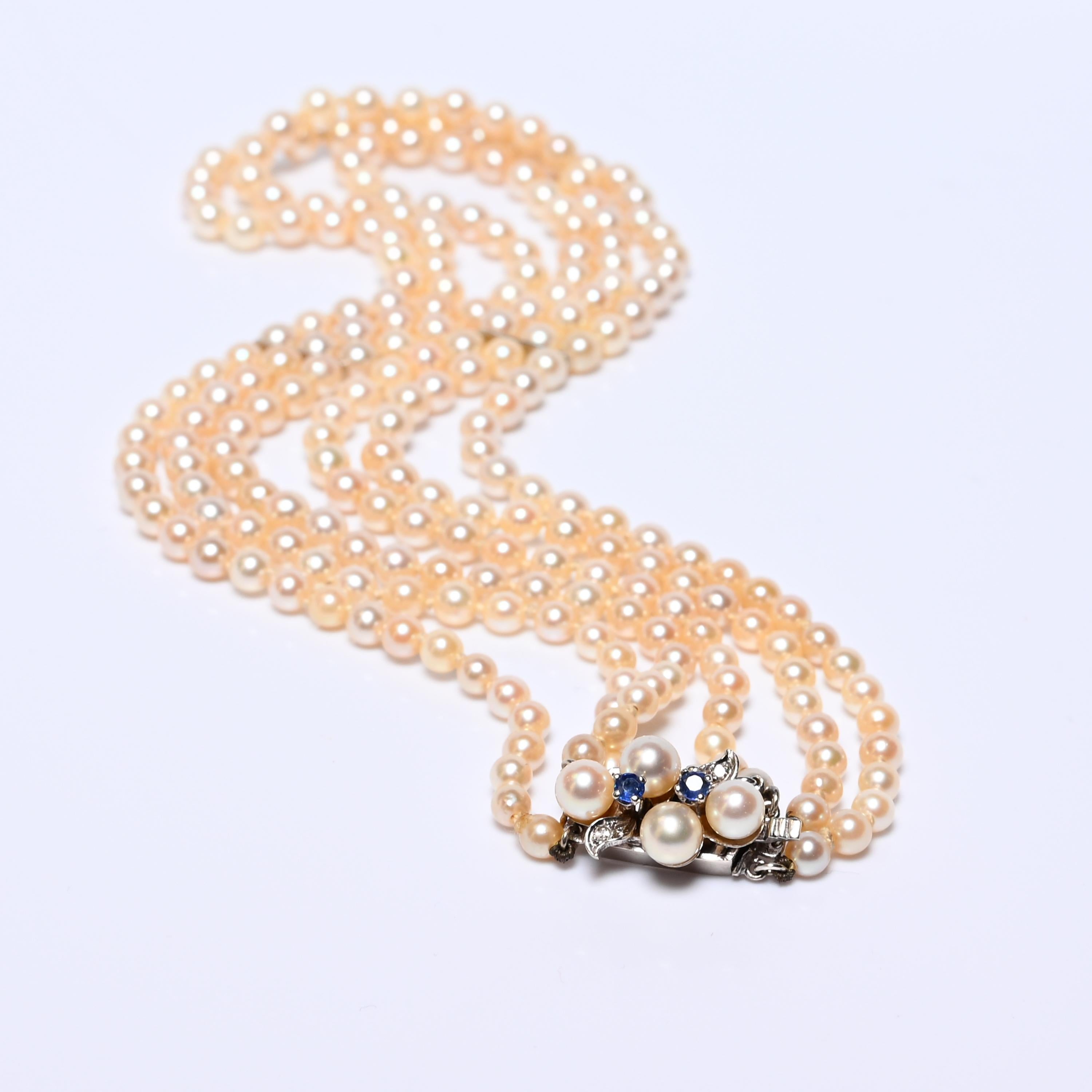 Round Cut Three-Strand Cultured Akoya Pearl Necklace with Sapphire Clasp, Circa 1930s–40s For Sale