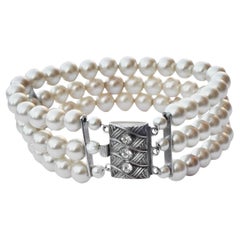 Three Strand Faux Pearl Bracelet with a Rhinestone Silver Tone Clasp