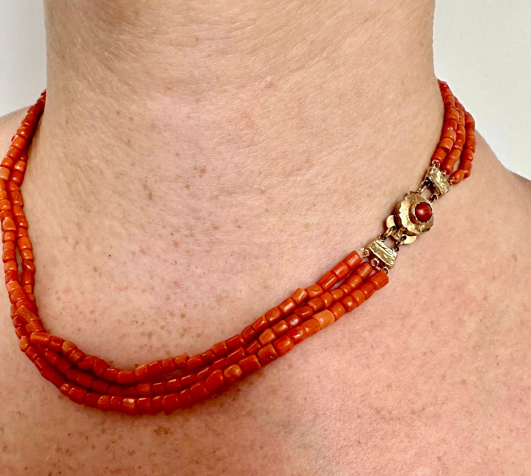 
A three strand of fine European natural red/salmon coral necklace beads about 3-4 mm. The coral beads are barrel-shaped and the handmade clasp is made of 14k yellow gold. The gold clasp is decorated with a small round coral. Very good condition.