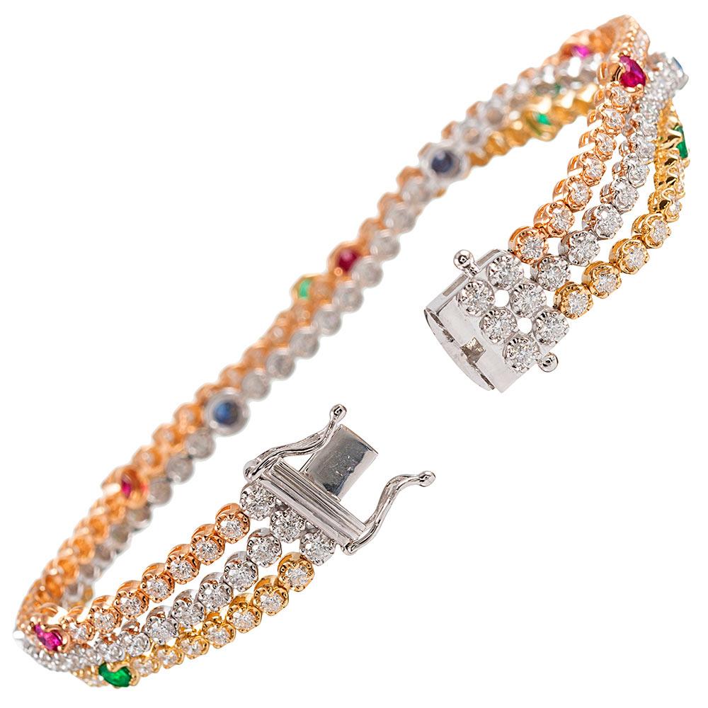 A beautiful contemporary creation, compliments of Simon G, the bracelet is rendered in white, yellow and rose gold. The three strands are connected at the ends and decorated with brilliant white diamonds (4.83 carats), blue sapphires (.62 carats),