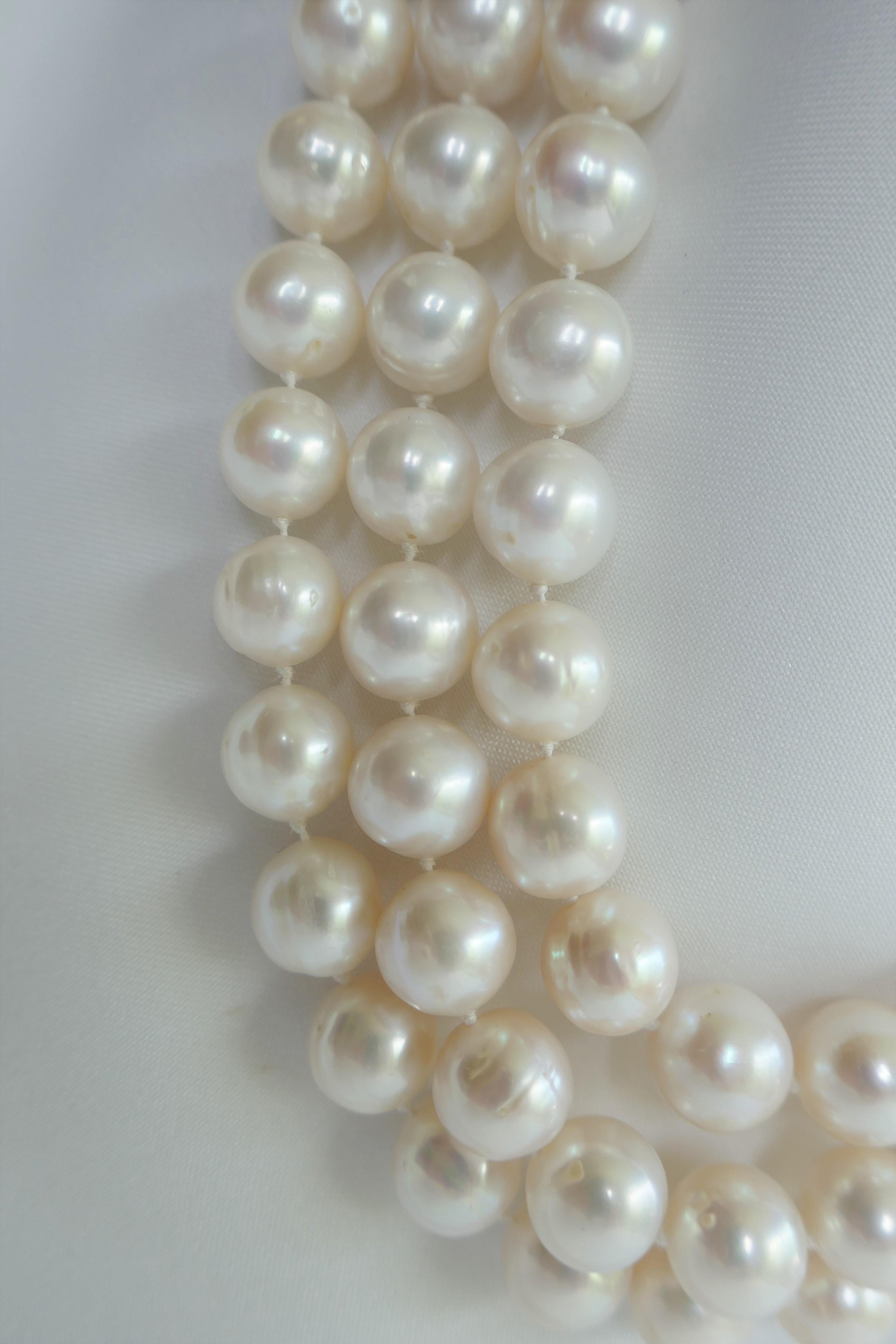 This three strand white cultured pearl necklace sits beautifully on the neck. The pearls are 10-11mm,  have great luster and little blemished. The necklace is individually knotted on silk thread. Although, a classical design the size make it more