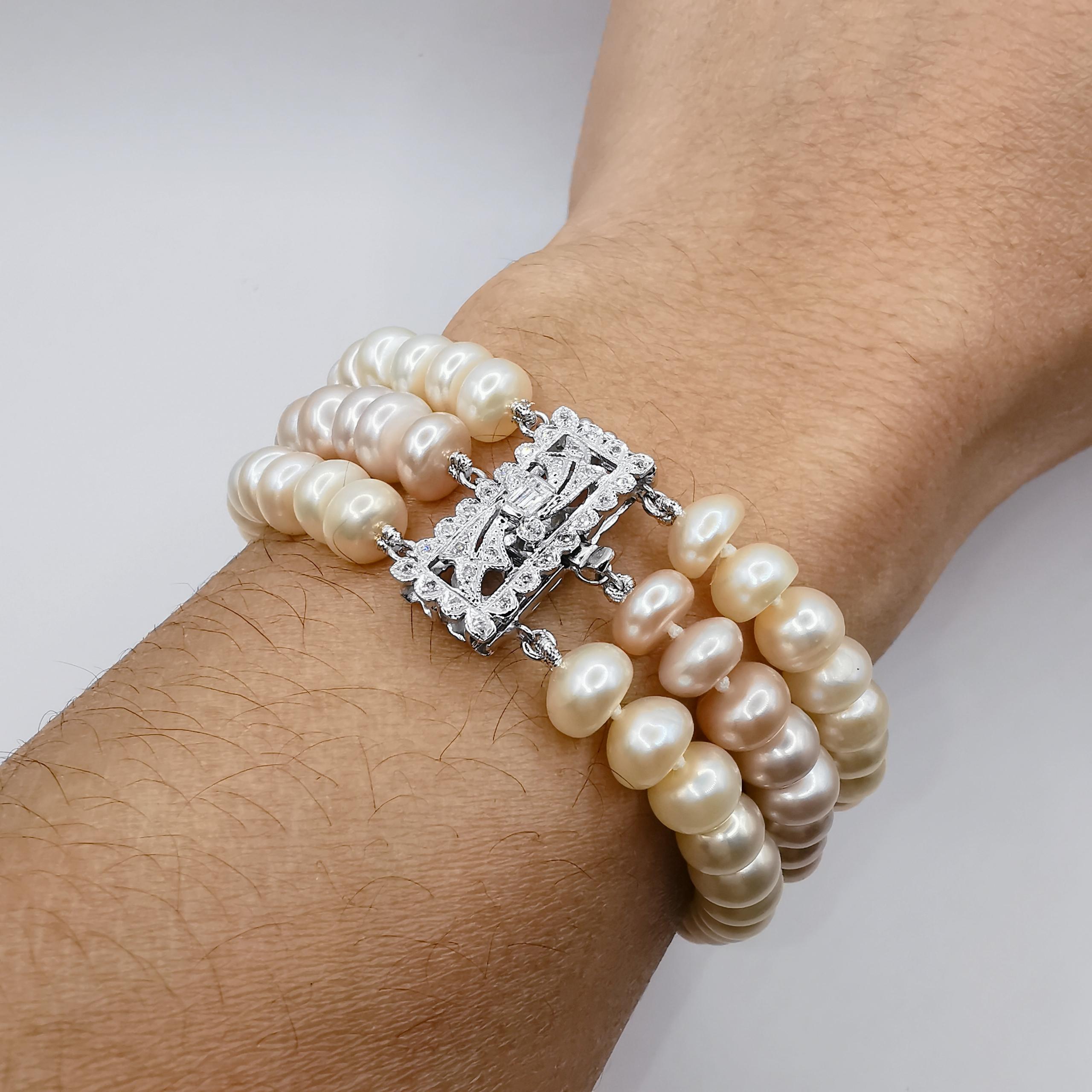 Introducing our stunning Three-Strand White & Pink Pearl Bracelet, set in 14K white gold. This bracelet features two strands of creamy white cultured pearls and one strand of pink cultured pearls, all measuring 7-8mm in diameter. The combination of