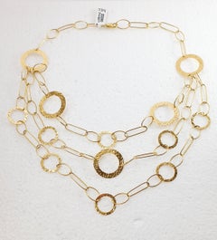 Three-Strand Yellow Gold Necklace with Rings of Different Sizes
