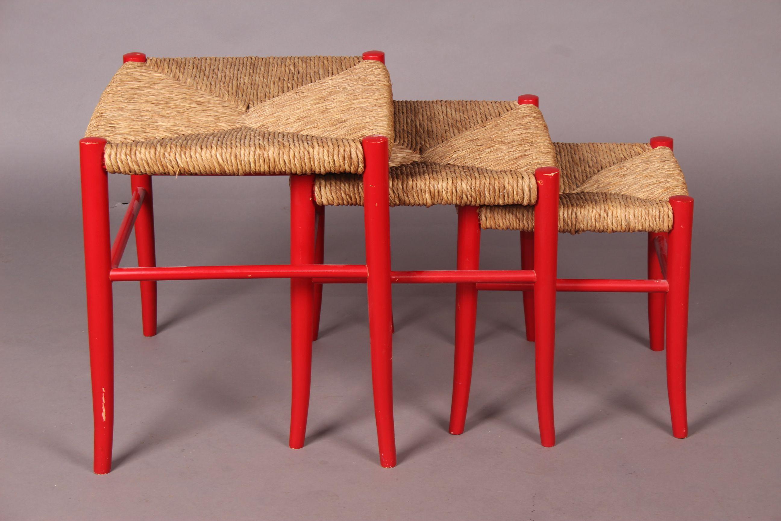Three straw and painted wood stools.