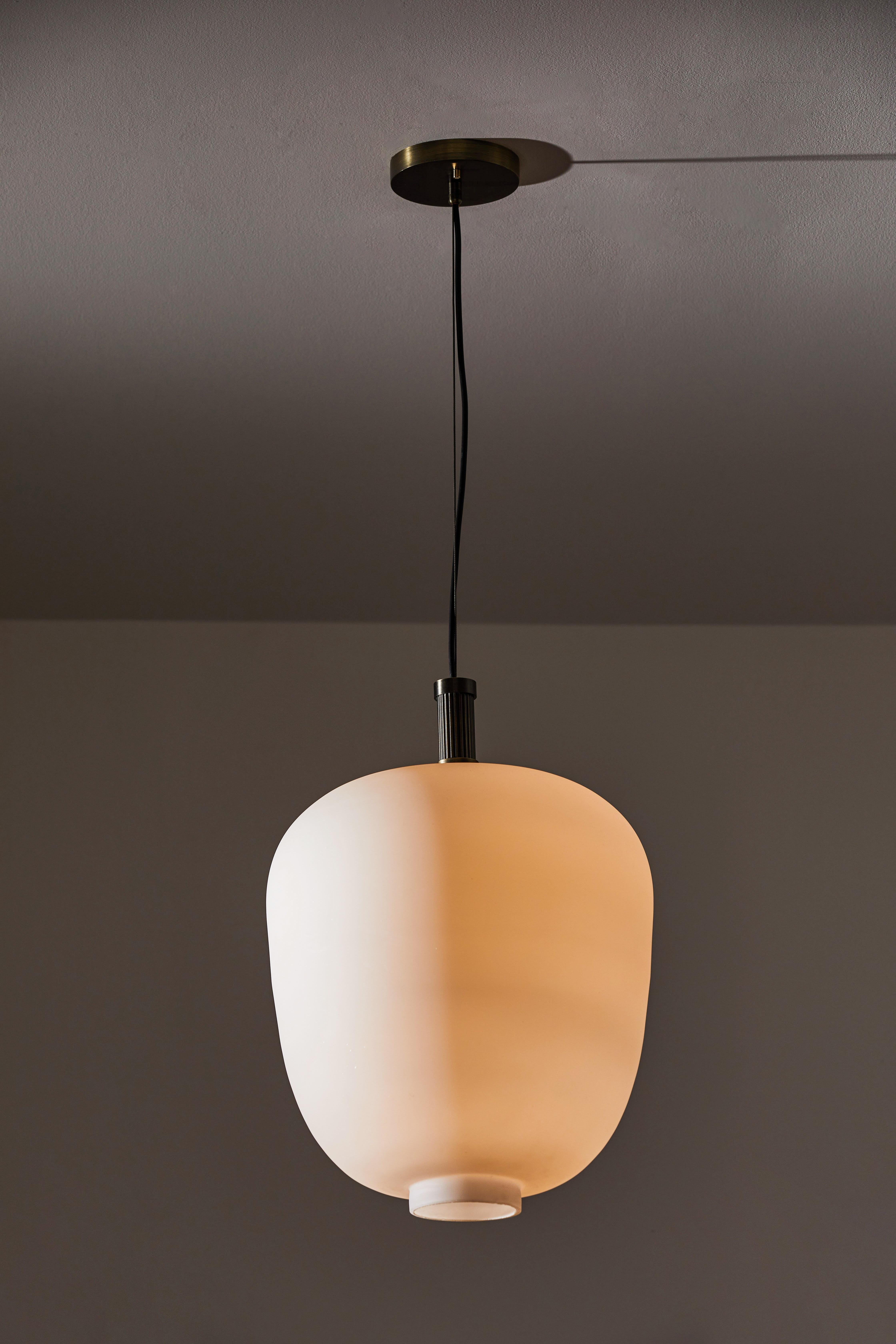 Two suspension light by Vilhelm Lauritzen. Designed and manufactured in Denmark, circa 1960s. Brushed satin glass diffuser, custom brass ceiling plate. Rewired for U.S. standards. We recommend one E27 100w maximum bulb per fixture. Light bulbs not