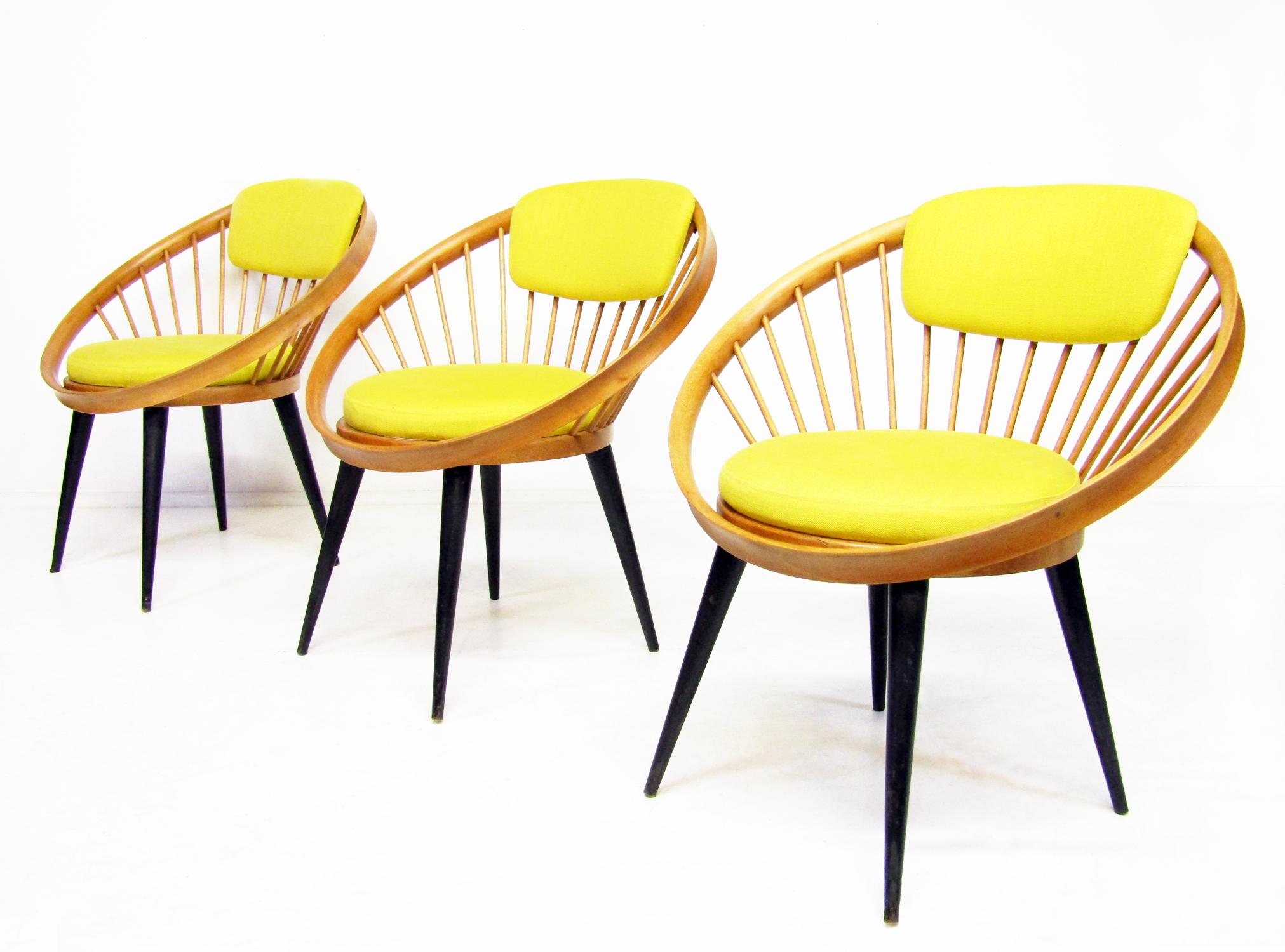 Three beautiful 1950s Laminett Circle chairs by Swedish designer Yngve Ekstrom.

With striking hoop frames on tapered legs, the seat and backrest in original yellow linen fabric, they resonate with 1950s chic.

They have been fully