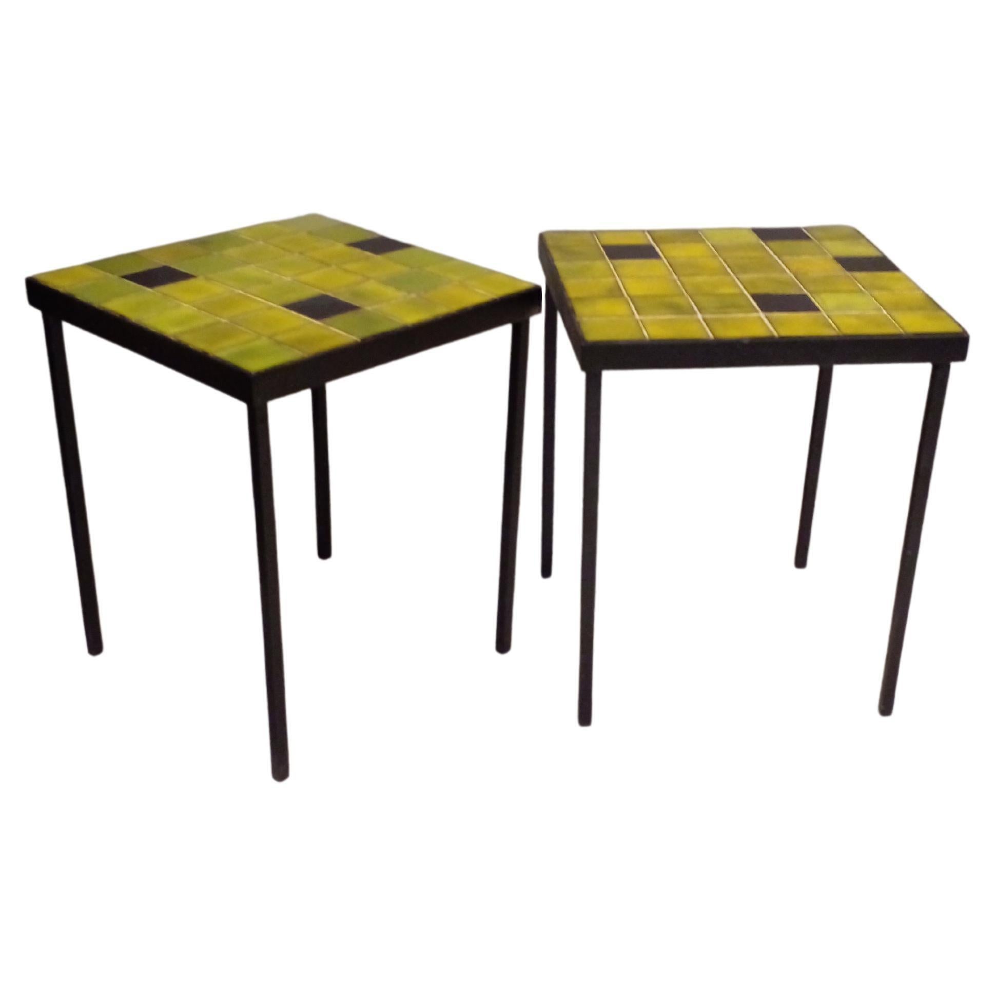  Mado Jolain and René Legrand around 1960. 
Three side tables including a pair, glazed ceramic tile tops in shades of green and black, France.
Bases in black lacquered iron.

Two tables
Width : 31.5 cm
Depth : 31.5 cm
Height : 37.5 cm
One