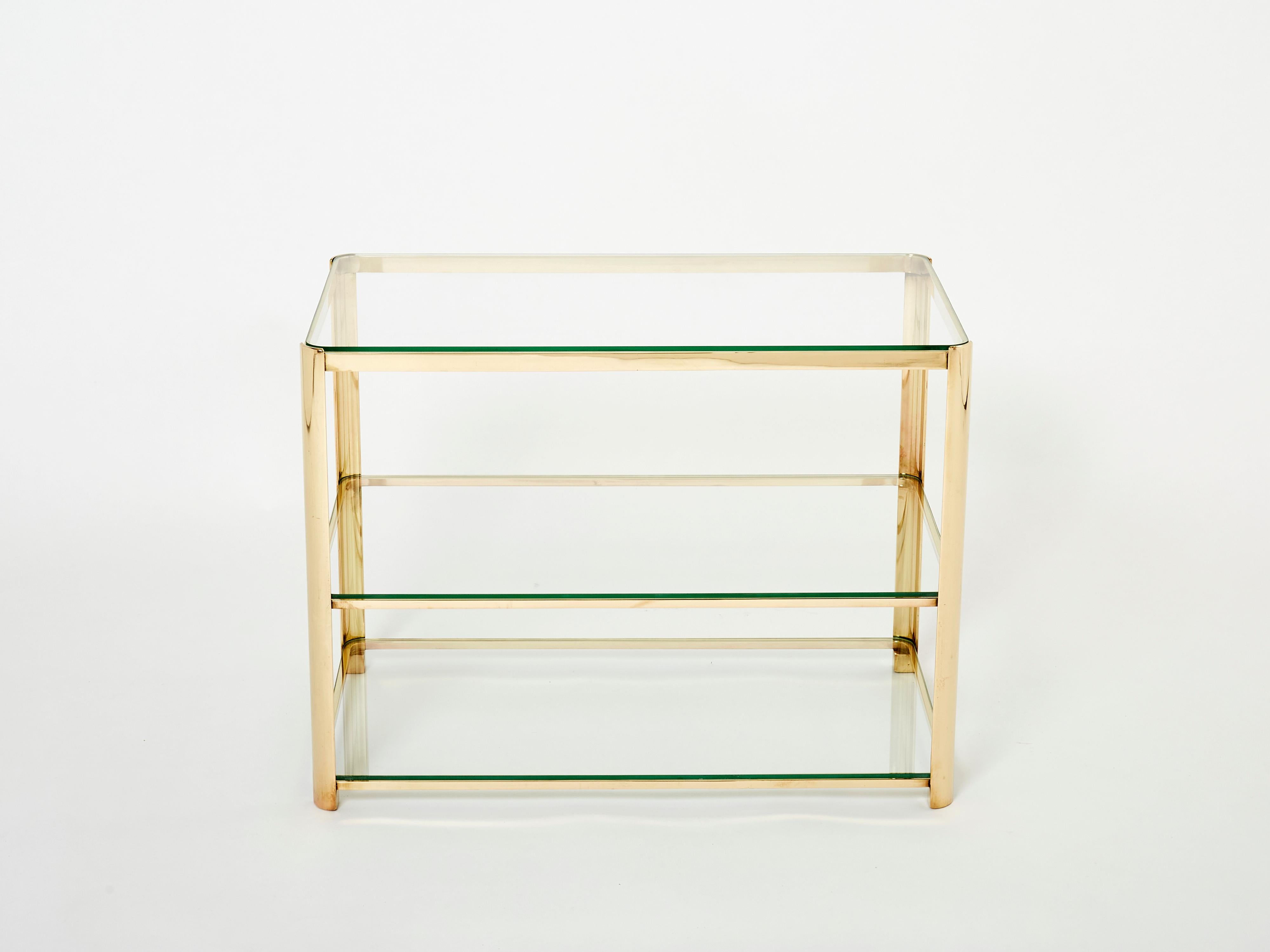 This beautiful three-tier side table designed by Jacques Quinet and stamped by Broncz, is a remarkable find. The table features a strong, solid polished bronze structure built to last forever. The original three-tier glass tops add a nice aesthetic