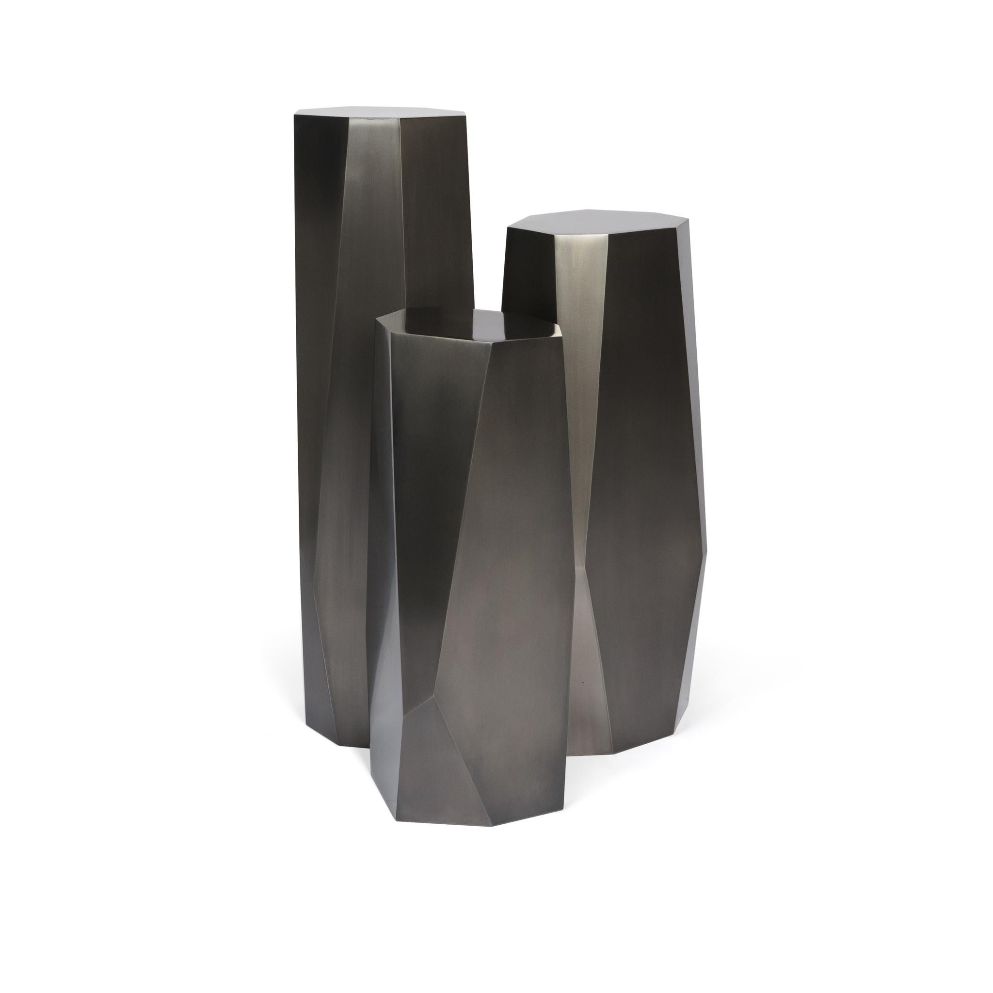 The hex column set is a three-piece elegant geometric pedestal set. The steel sculptural and hand applied finish make this set an interesting conversation piece. Its geometric design reflects light and illuminates light and shadows from different
