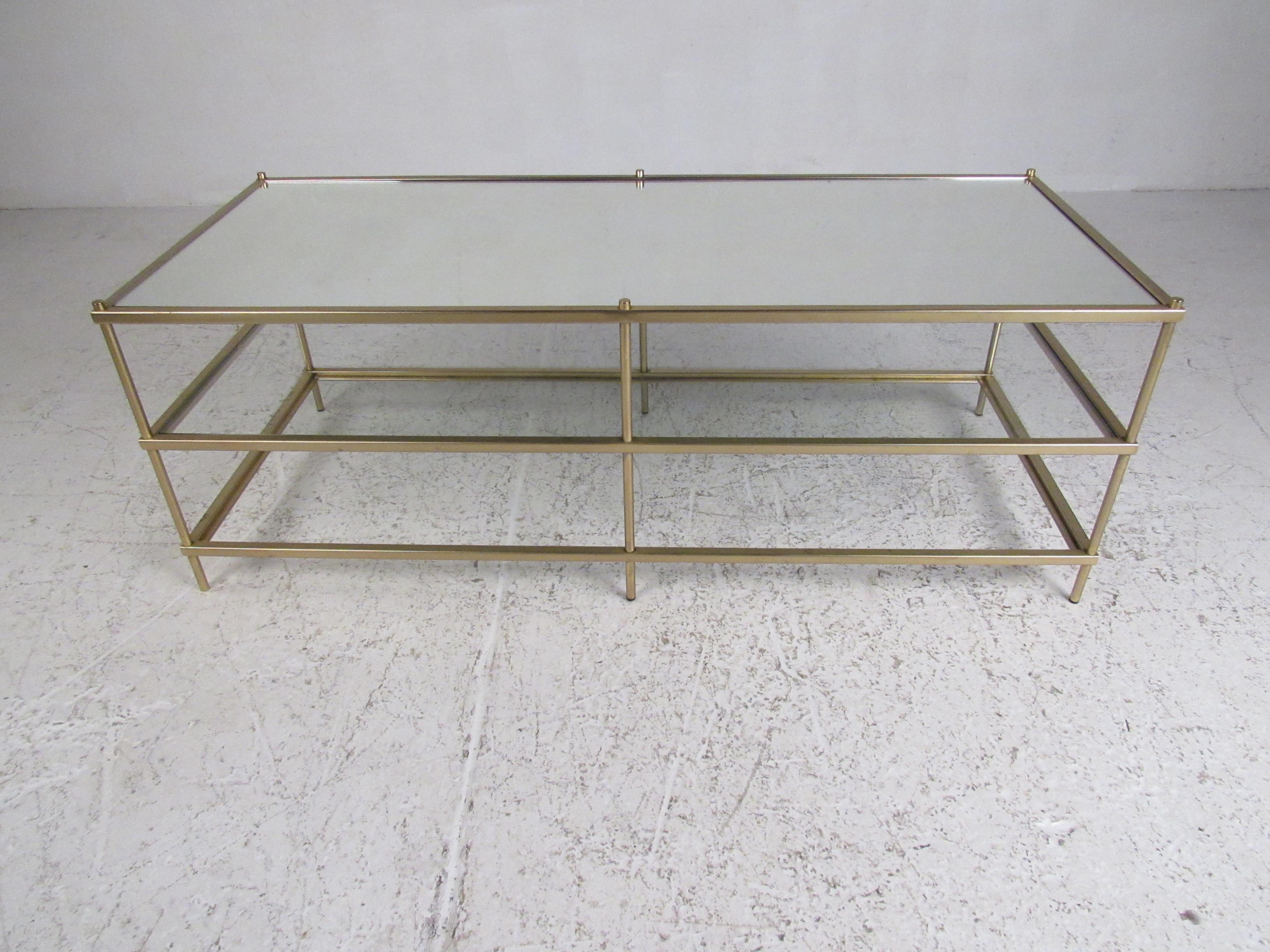 This unique vintage modern rectangle cocktail table features three tiers of glass. Sleek design with a sturdy bar metal frame connecting each tier. This unusual table allows for extra storage or gives one the ability to display items in between each