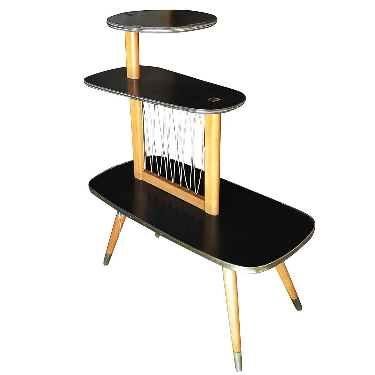 Set of two Mid-century side tables with string art center design featuring black Formica tops with brass trim and tapered legs.

There are two tall tables in this set. Made in France

Measures: Tall table H 33 in. x W 13.5 in. x D 27 in.
 