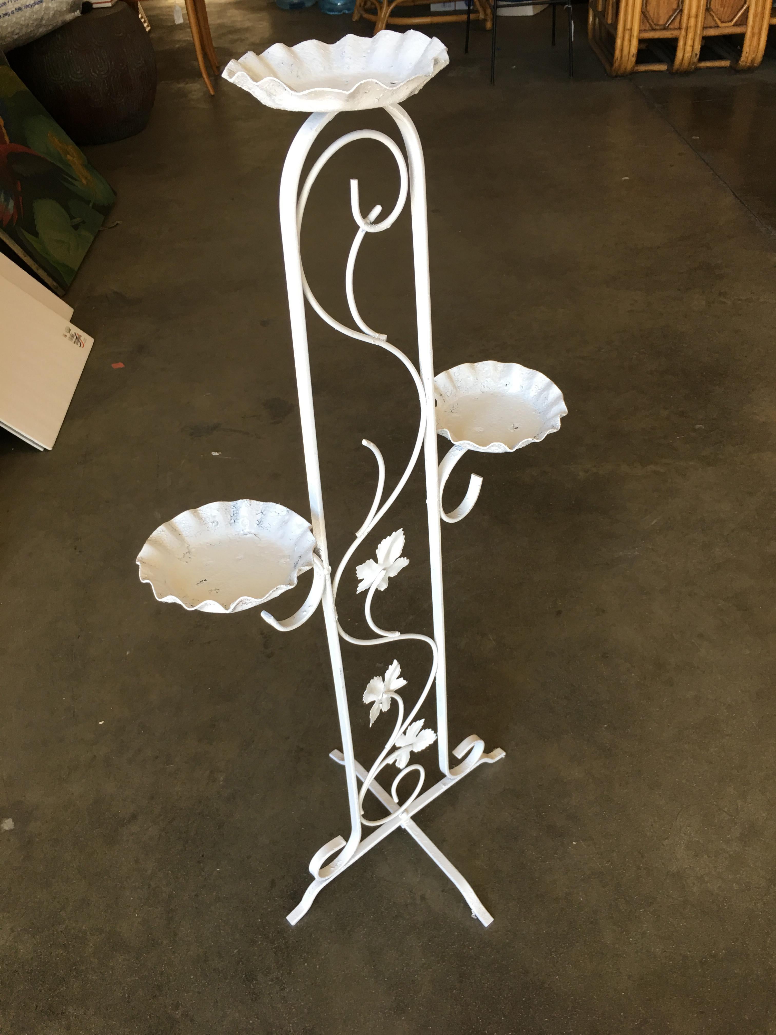 Three-tier outdoor/patio plant stand with scrolling pattern base, circa 1950.