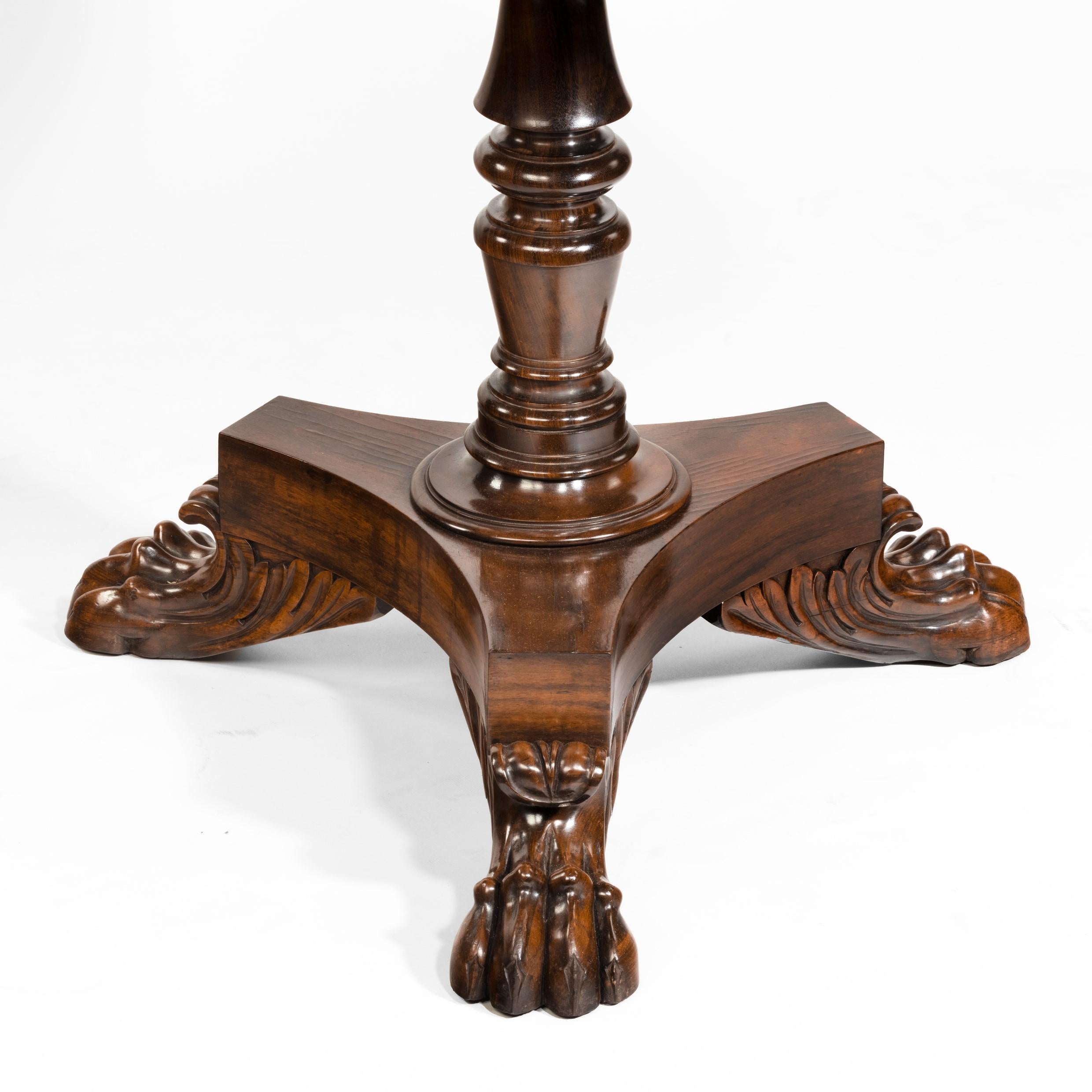 A three-tier Regency Gonçalo Alves dumb waiter, with three graduated, revolving, circular shelves on a turned, flanged support and raised on a tripod base, with three lion’s paw feet. English, circa 1820.