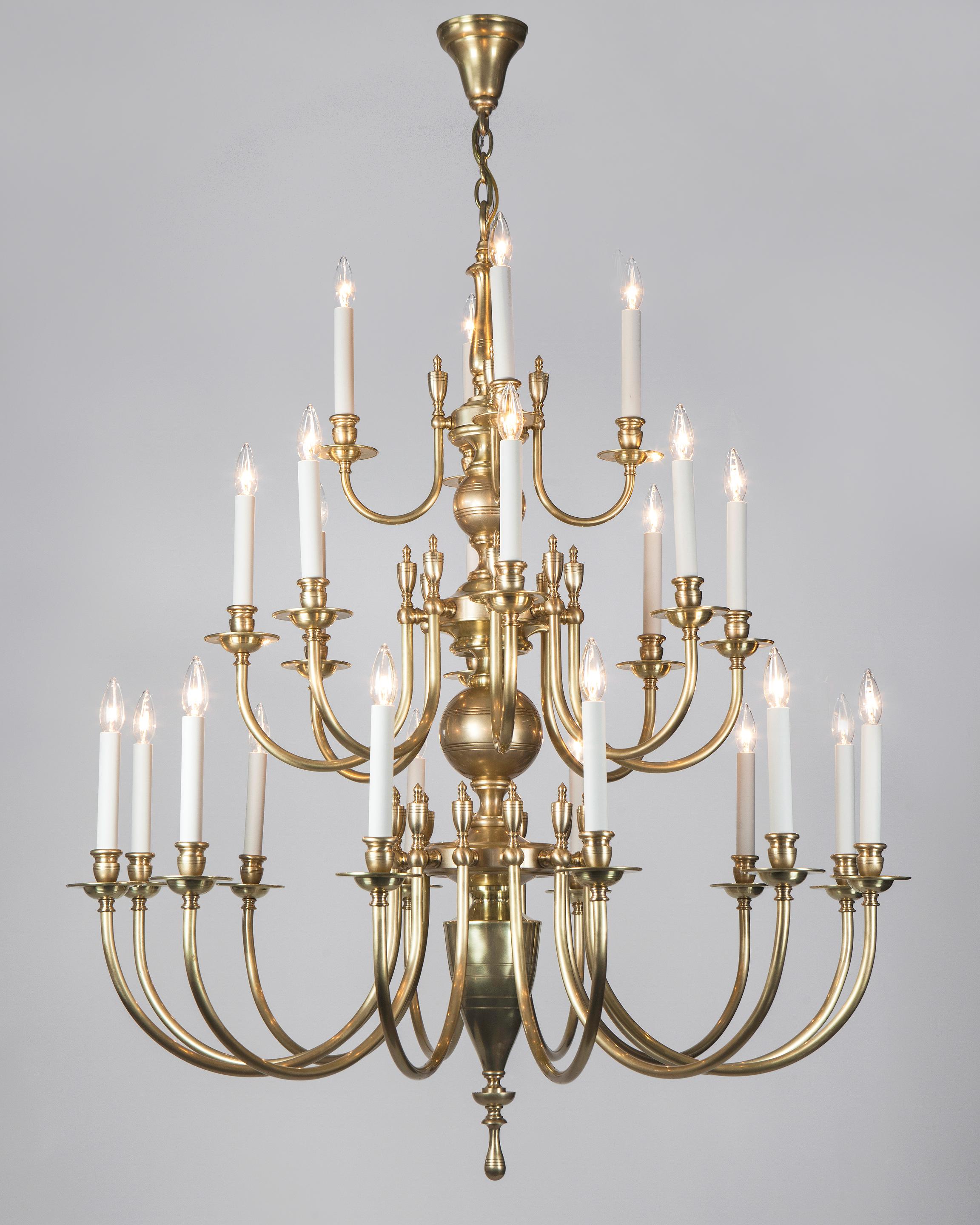 HL1293.24
The Astrid 24 chandelier by Remains Lighting is a large 24-light solid brass chandelier having three tiers of four over eight over twelve arms arrayed on a baluster-form stem. Subtle linear details are incised on the central ball,