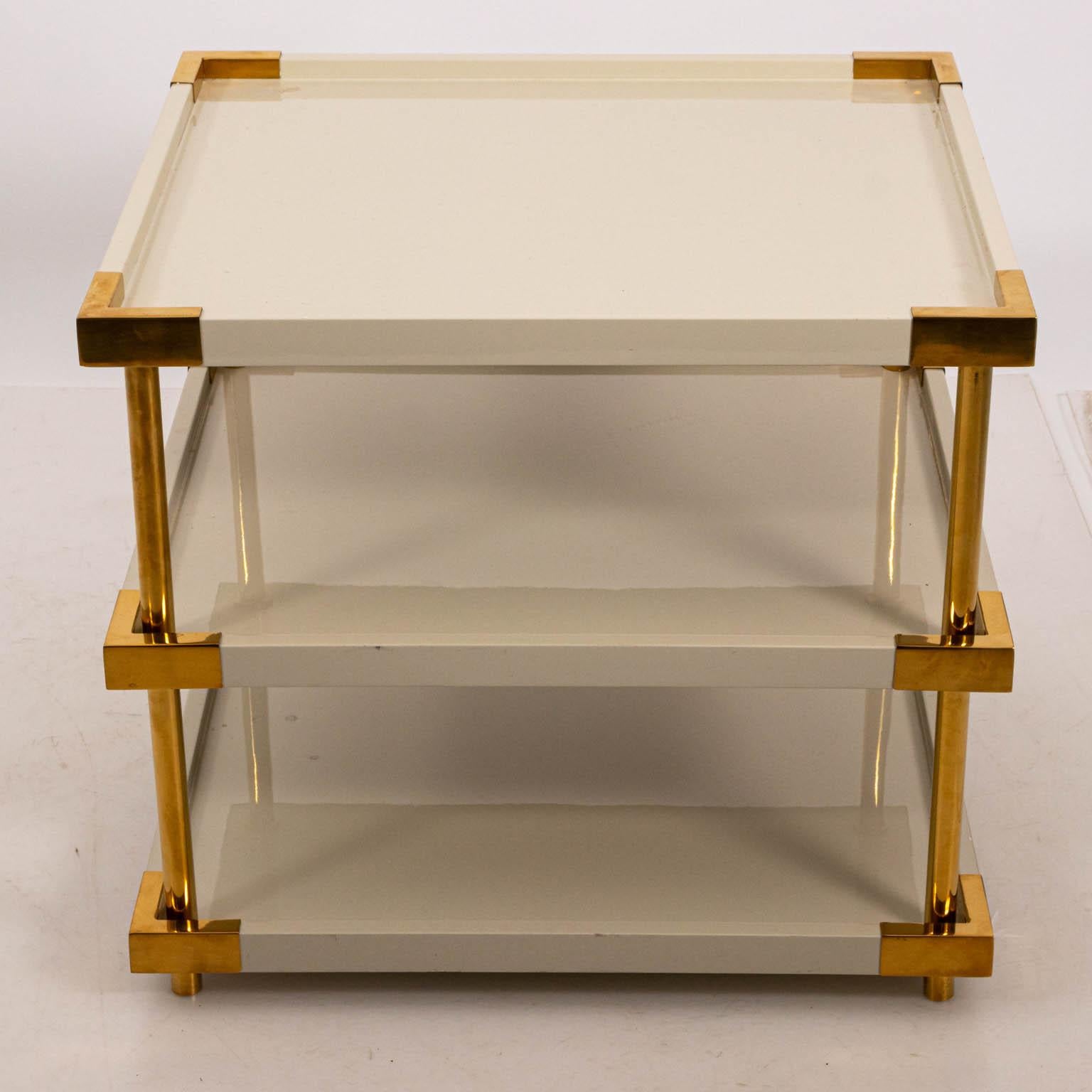 Contemporary style square three tier table with brass mounts, circa 2010. The piece is also lacquered in white. Please note of wear consistent with age including surface scratches. Made in the United States.