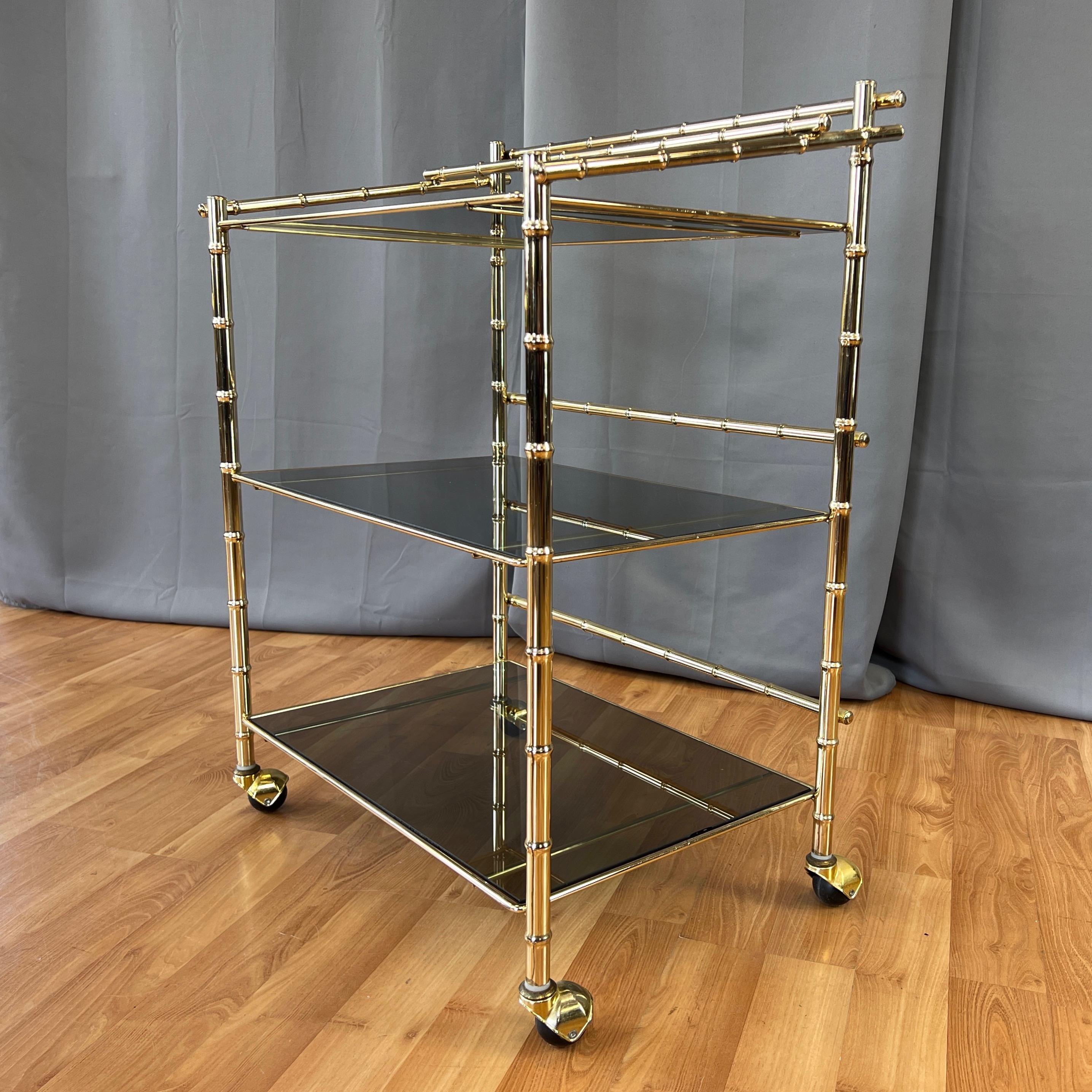 Hollywood Regency Three-Tiered Brass Faux Bamboo and Smoked Glass Bar Cart, 1970s For Sale