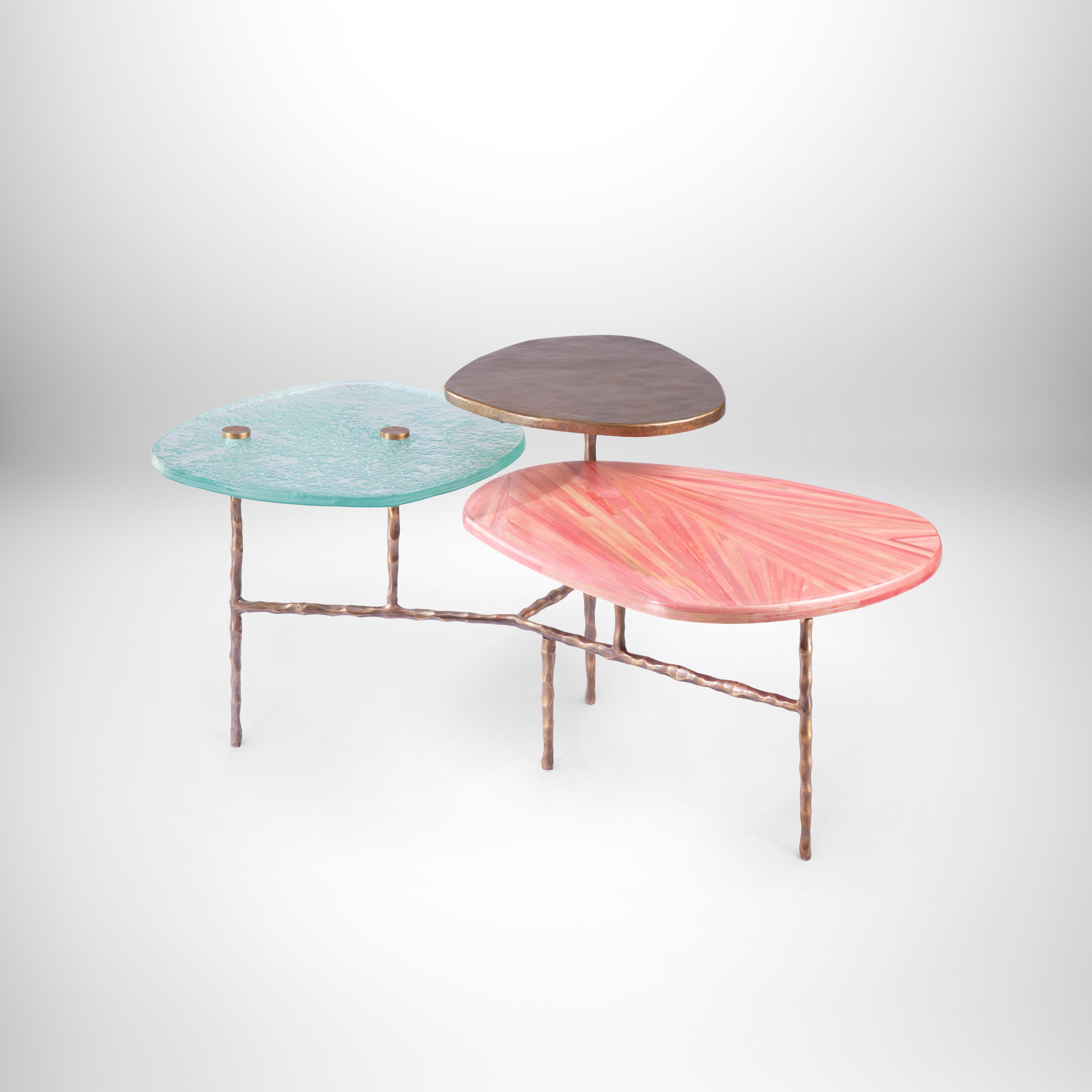 Three-tiered coffee table with hand-laid pink straw, brass & custom-made glass.
This timeless design unites beauty, class and pragmatism. Three tiered pedals resemble that of a flower each made from a different material that complements each other.