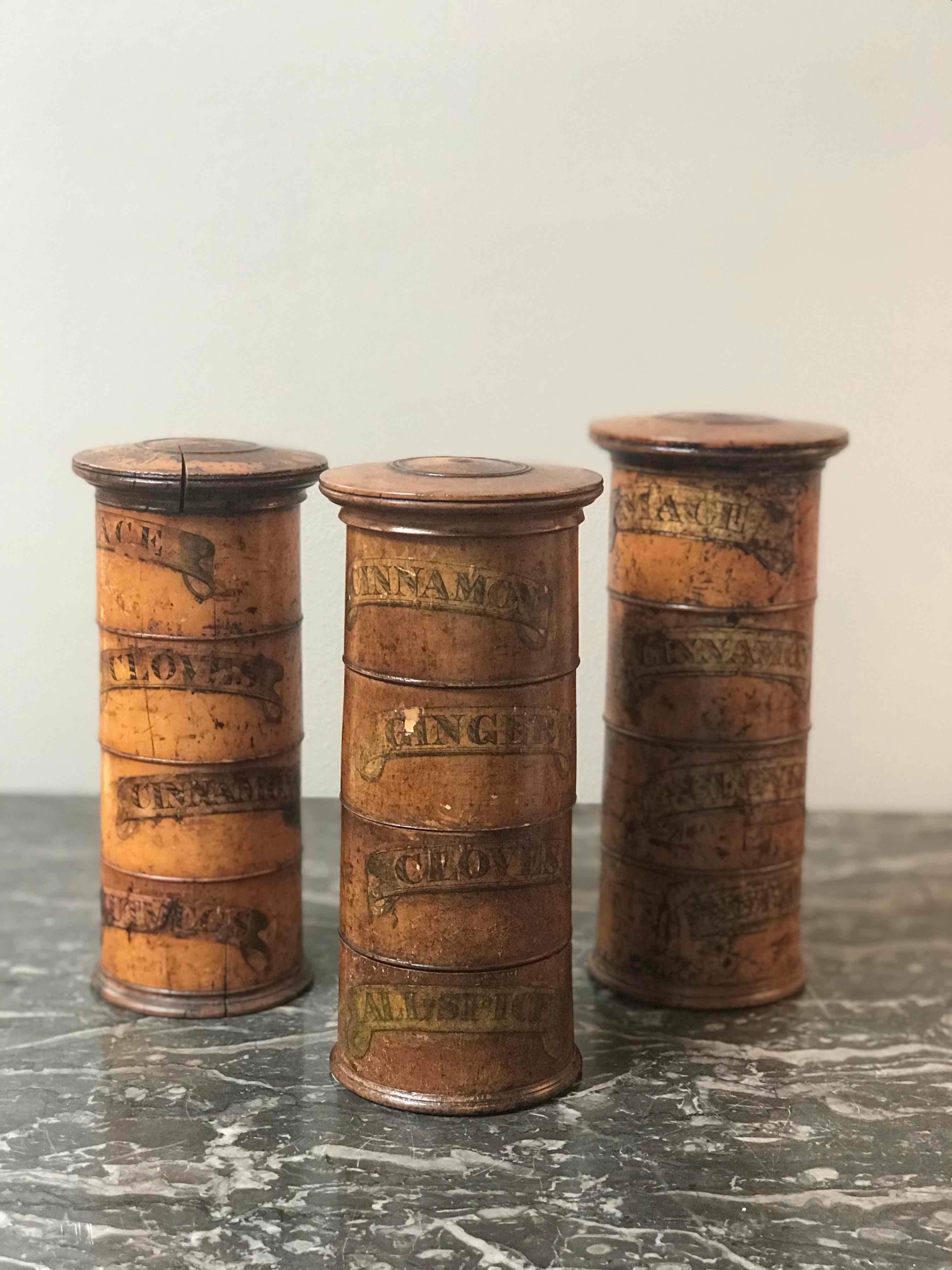 Three-tiered wooden spice tower from mid 19th-century England. With compartments beautifully labeled for cinnamon, cloves, ginger, and allspice, this rustic wooden vessel has taken on a unique patina over its life. The charming typography harkens