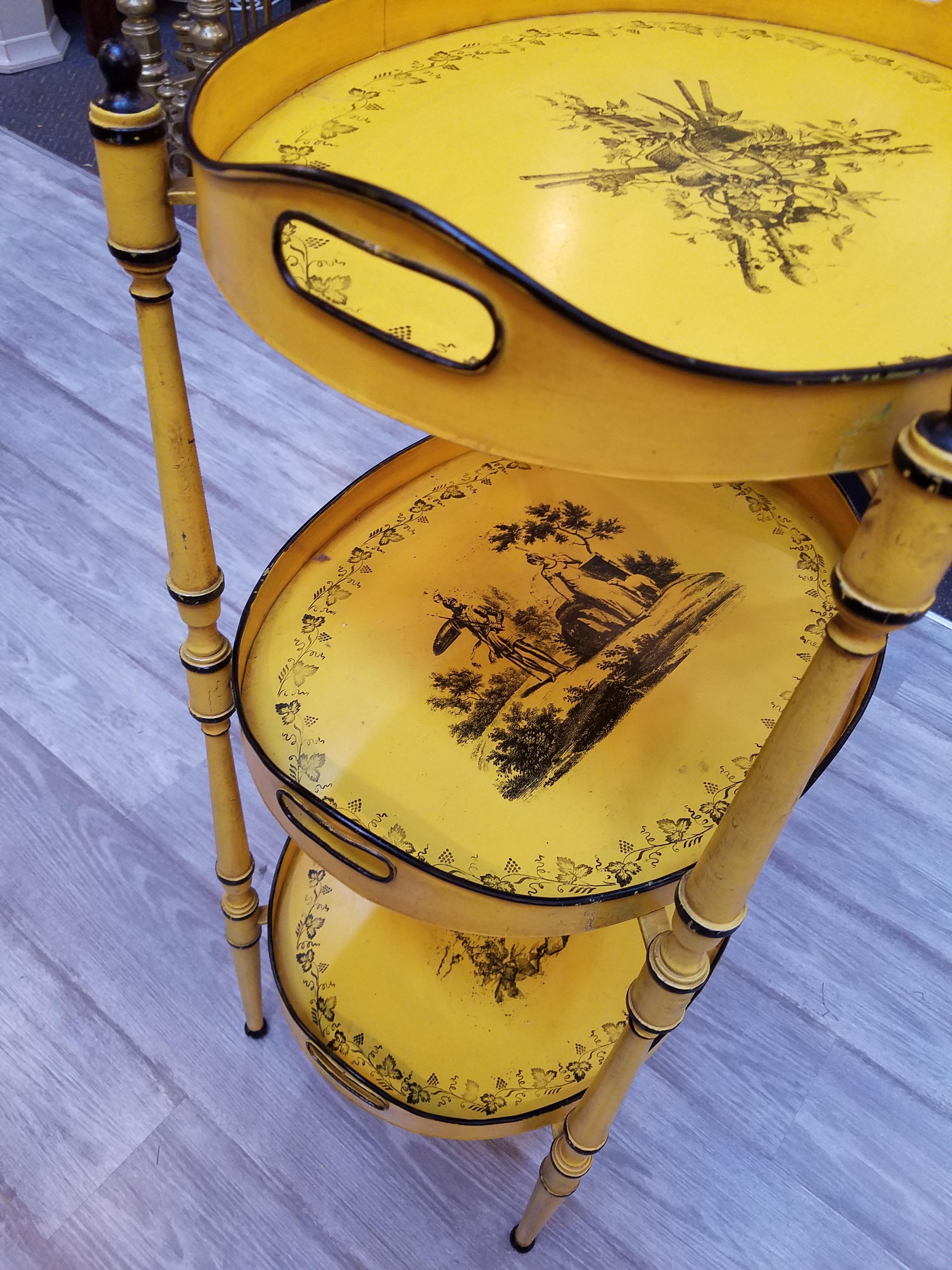 A three-tier canary yellow and black tole Stand with removeable trays hand painted in the French Creil style, 1960s.
  