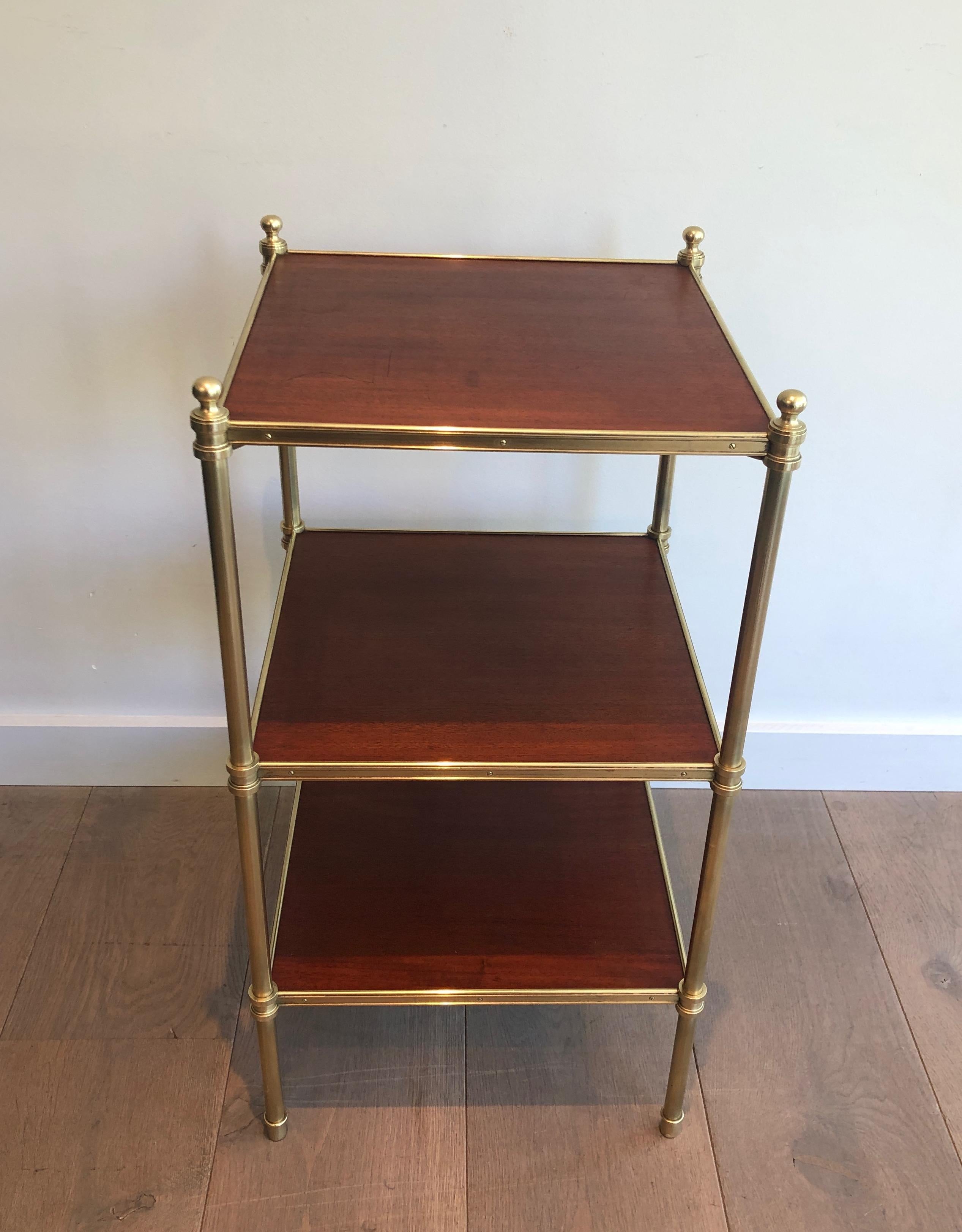 This neoclassical style 3 tiers side table is made of mahogany and brass. This is a French work by famous designer Maison Jansen, circa 1940.