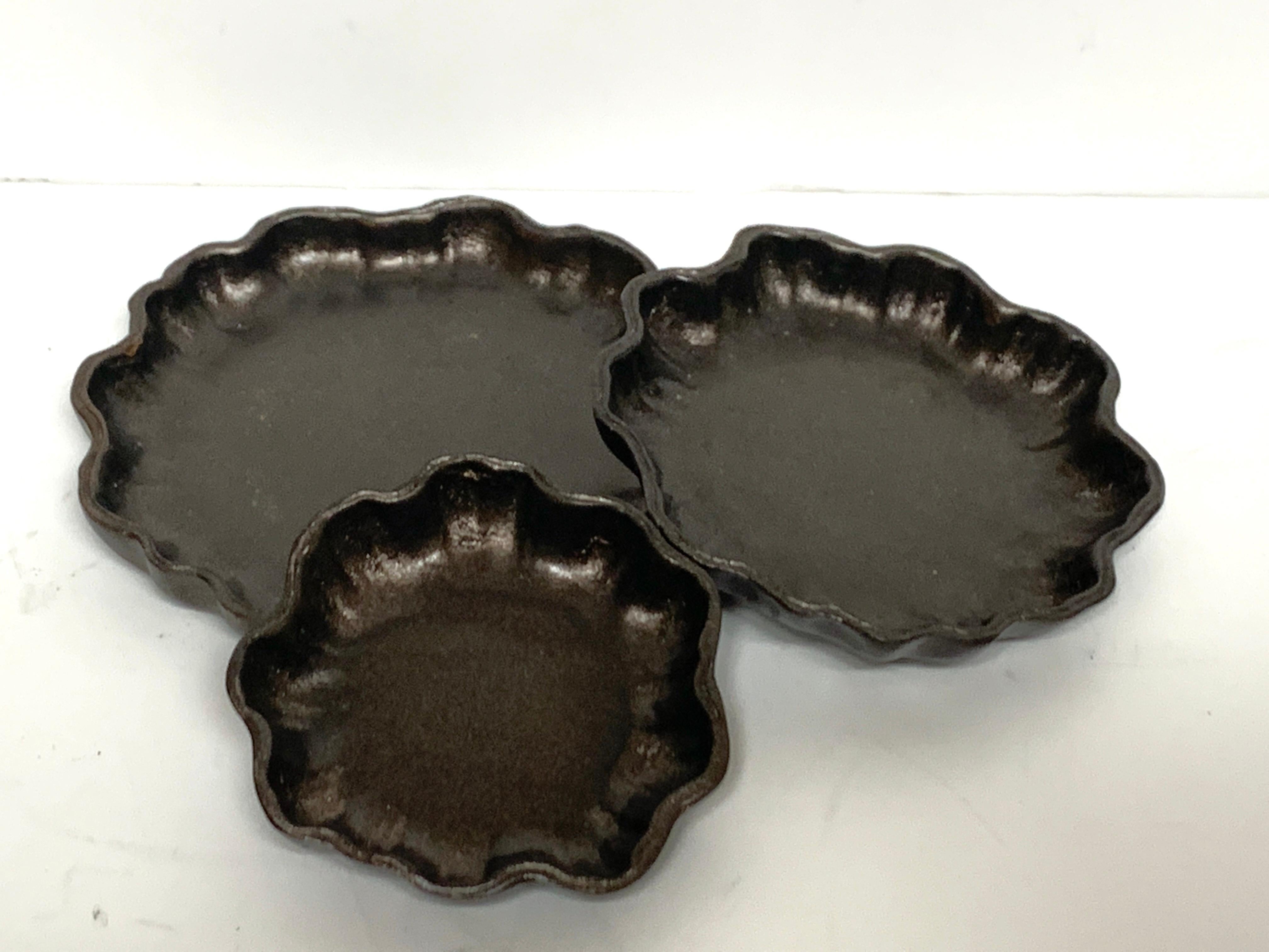 Three Tiffany Studios bronze graduating lily pad dishes
All pieces marked with Tiffany Studios New York, and 