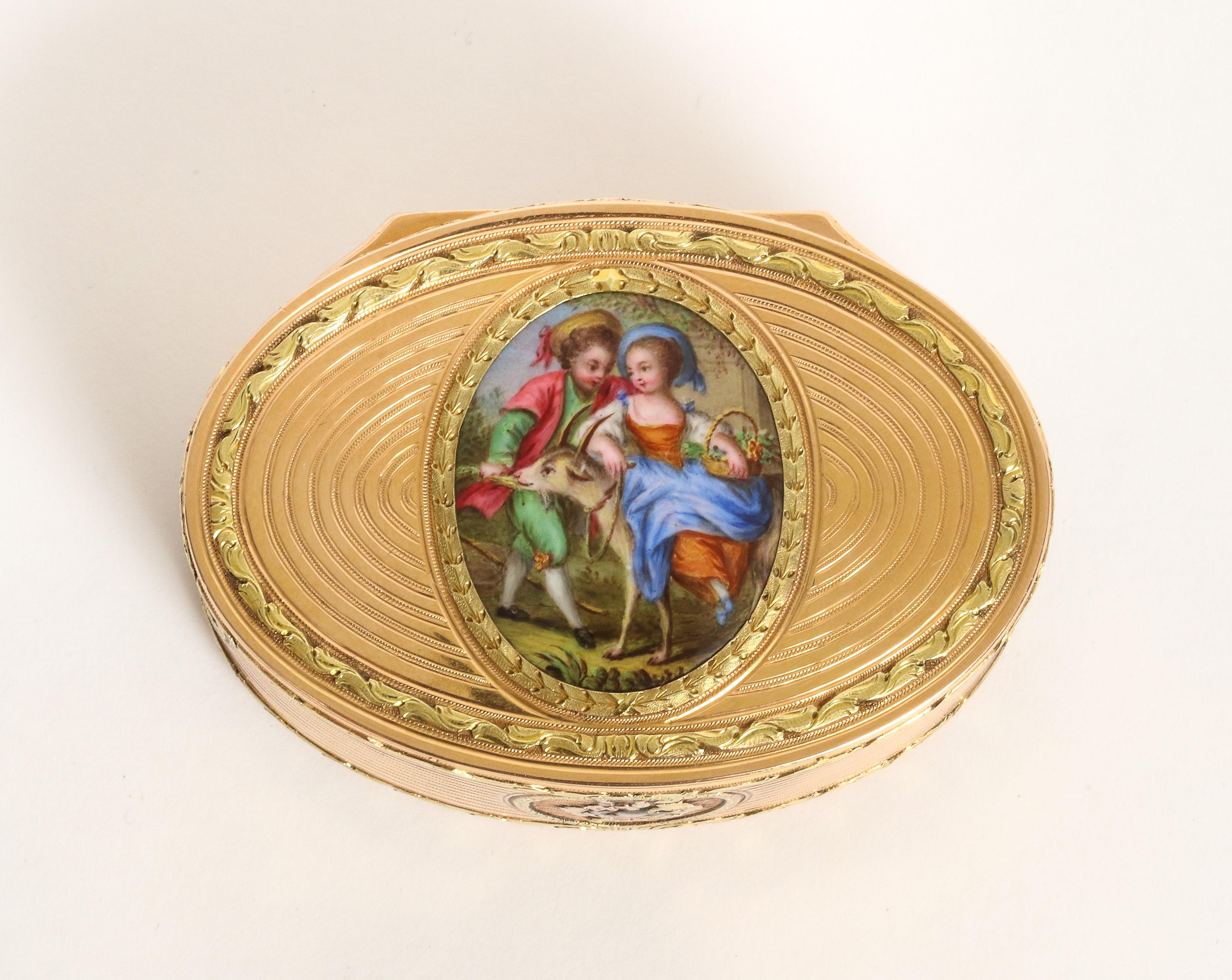 Three-tone gold oval enamel snuff box with with repoussé gold work of musical instruments
Enamel plaque center
Circa late 18th century - early 19th century, Switzerland
Weight: 76.5g
Dimensions: Approximately length: 2.59 in, width: 1.81 in,